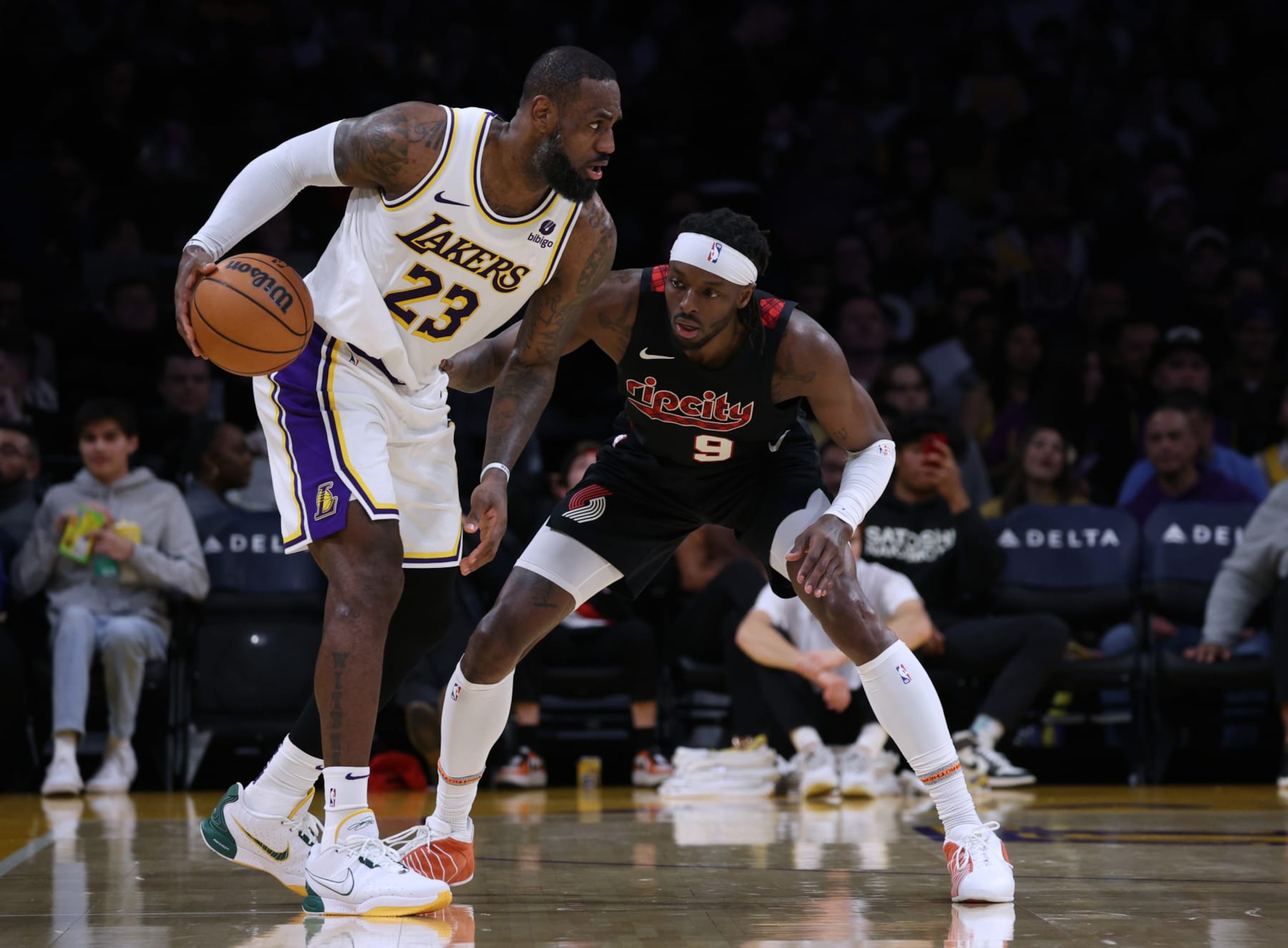 LOS ANGELES, CALIFORNIA - JANUARY 21: LeBron James #23 of the Los Angeles Lakers dribbles as he is guarded by Jerami Grant #9 of the Portland Trail Blazers during a 134-110 win over the Portland Trail Blazers at Crypto.com Arena on January 21, 2024 in Los Angeles, California. User is consenting to the terms and conditions of the Getty Images License Agreement. (Photo by Harry How/Getty Images)