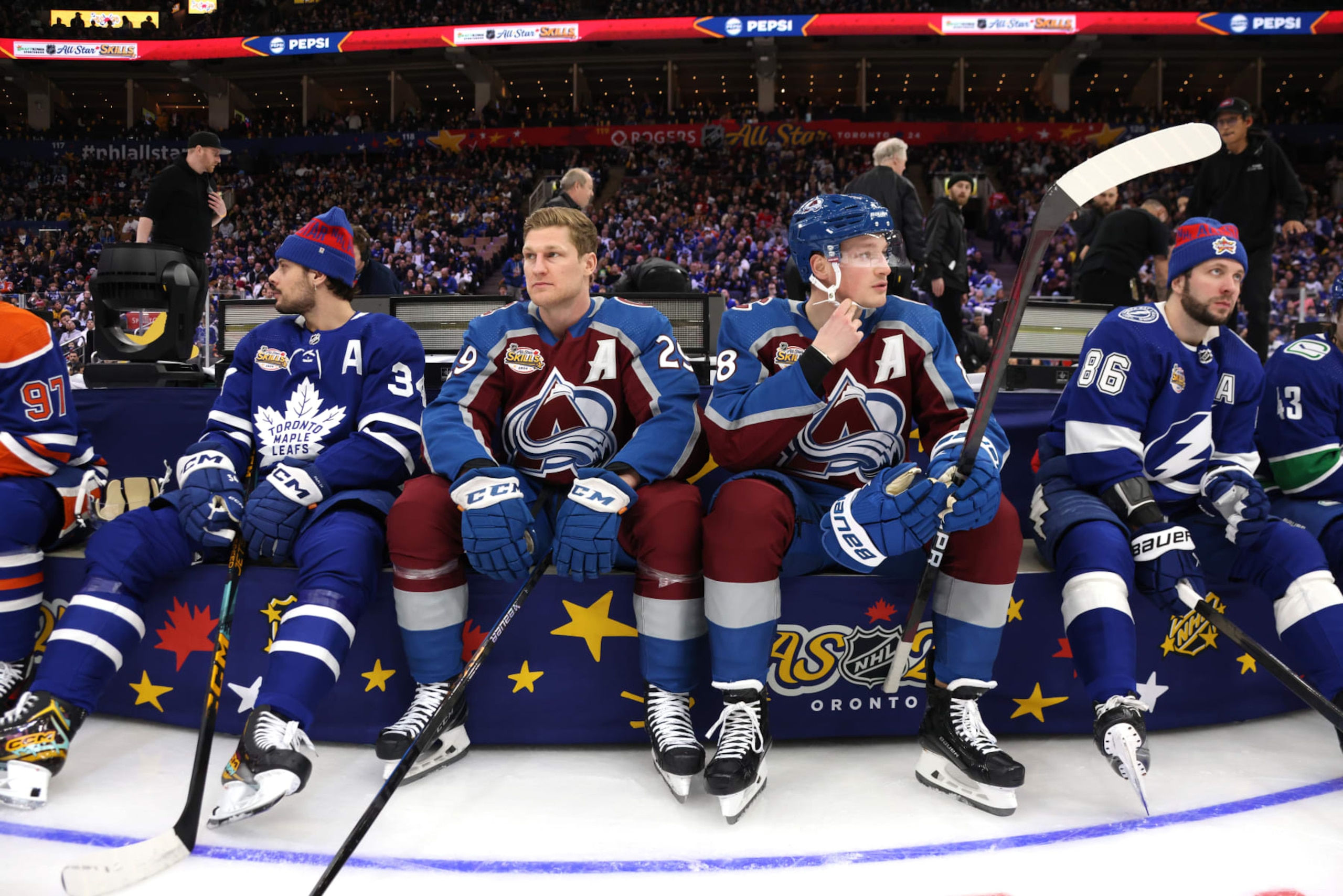 TORONTO, ONTARIO - FEBRUARY 02: (L-R) Auston Matthews #34 of the Toronto Maple Leafs, Nathan MacKinnon #29 of the Colorado Avalanche, Cale Makar #8 of the Colorado Avalanche and Nikita Kucherov #86 of the Tampa Bay Lightning look on during the 2024 NHL All-Star Skills Competition at Scotiabank Arena on February 02, 2024 in Toronto, Ontario, Canada. (Photo by Dave Sandford/NHLI via Getty Images)