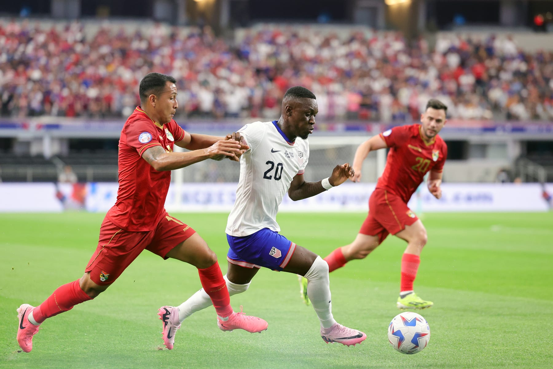 ARLINGTON, TEXAS - JUNE 23: Folarin Balogun #20 of the United States plays the ball under pressure during the first half against Bolivia at AT&T Stadium on June 23, 2024 in Arlington, Texas. (Photo by Carmen Mandato/USSF/Getty Images for USSF)