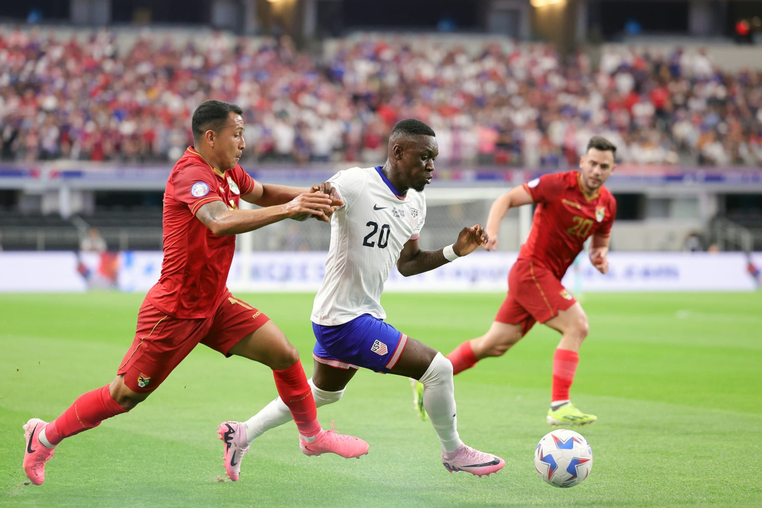 ARLINGTON, TEXAS - JUNE 23: Folarin Balogun #20 of the United States plays the ball under pressure during the first half against Bolivia at AT&T Stadium on June 23, 2024 in Arlington, Texas. (Photo by Carmen Mandato/USSF/Getty Images for USSF)