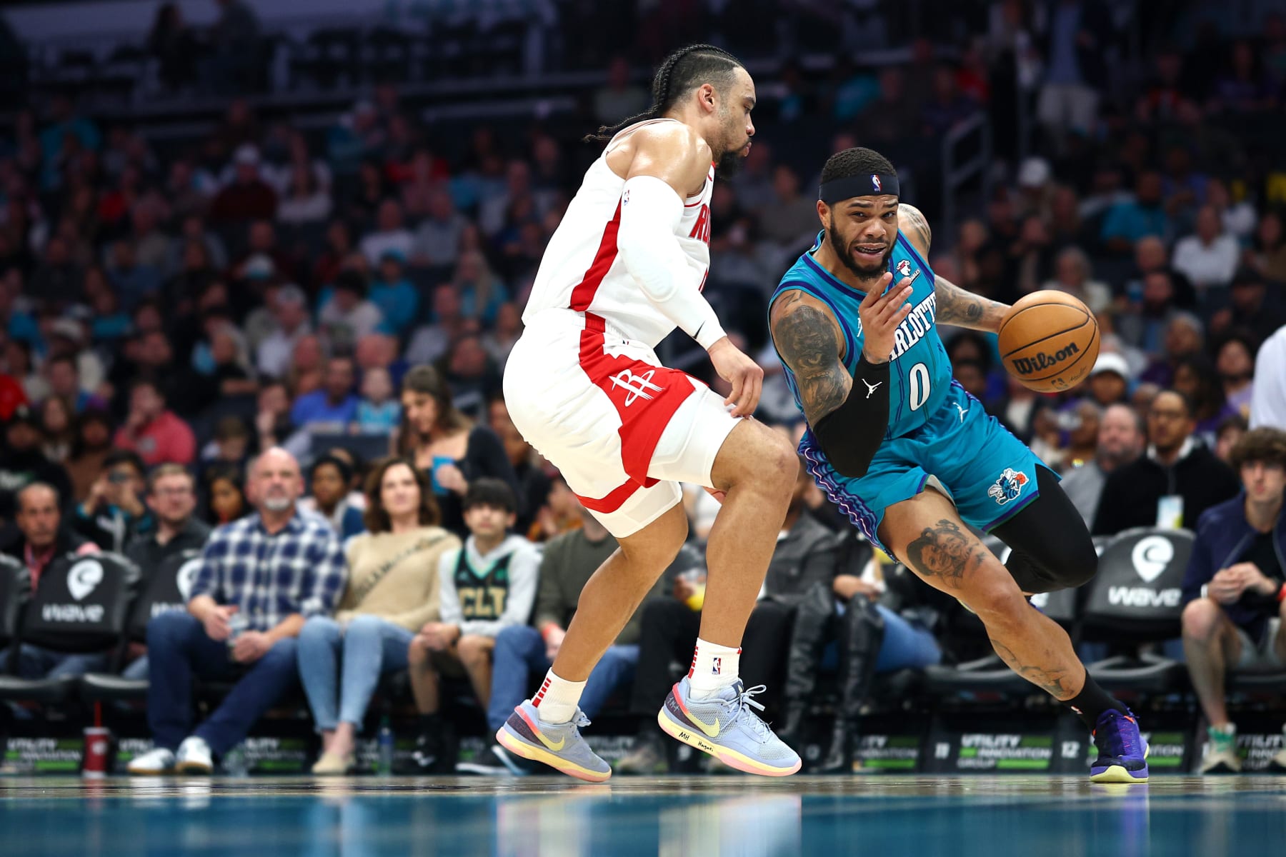 CHARLOTTE, NORTH CAROLINA - JANUARY 26: Miles Bridges #0 of the Charlotte Hornets drives to the basket against Dillon Brooks #9 of the Houston Rockets during the second half of the game at Spectrum Center on January 26, 2024 in Charlotte, North Carolina. NOTE TO USER: User expressly acknowledges and agrees that, by downloading and or using this photograph, User is consenting to the terms and conditions of the Getty Images License Agreement. (Photo by Jared C. Tilton/Getty Images)