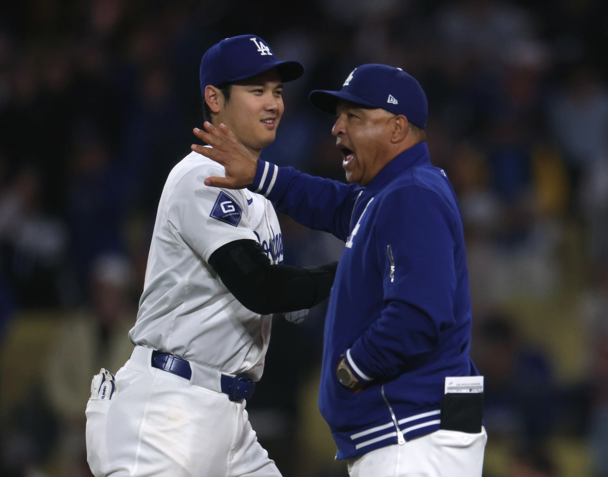 LOS ANGELES, CALIFORNIA - JUNE 01: Shohei Ohtani #17 and Dave Roberts #30 of the Los Angeles Dodgers react after a 4-1 win over the Colorado Rockies at Dodger Stadium on June 01, 2024 in Los Angeles, California. (Photo by Harry How/Getty Images)