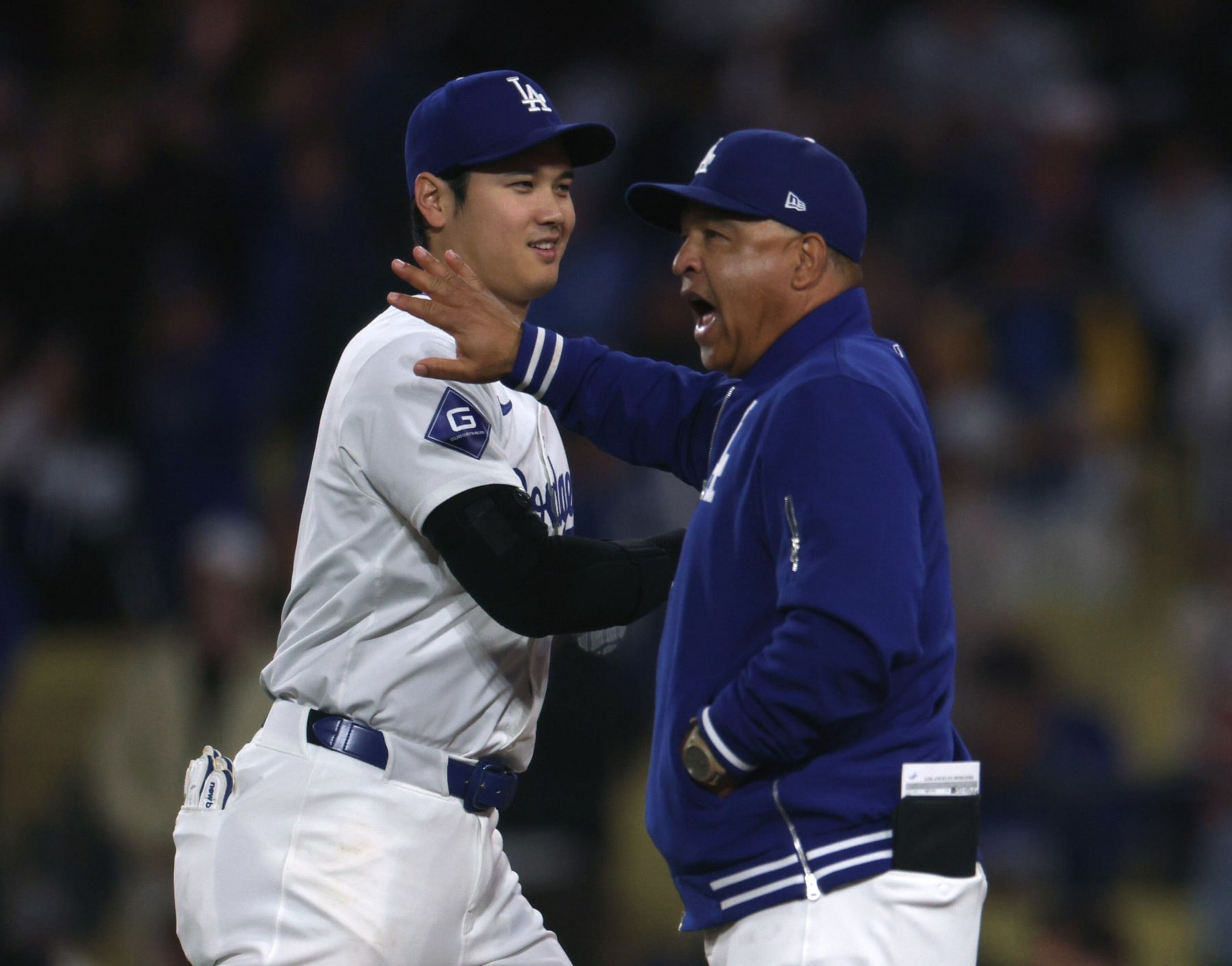 LOS ANGELES, CALIFORNIA - JUNE 01: Shohei Ohtani #17 and Dave Roberts #30 of the Los Angeles Dodgers react after a 4-1 win over the Colorado Rockies at Dodger Stadium on June 01, 2024 in Los Angeles, California. (Photo by Harry How/Getty Images)