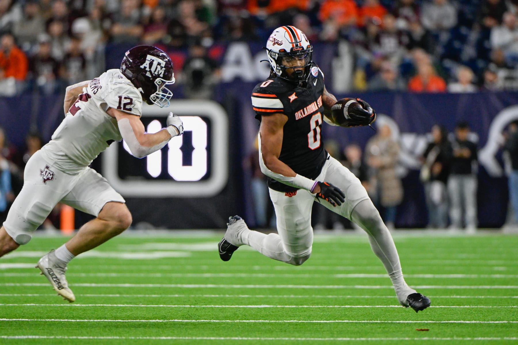 HOUSTON, TX - DECEMBER 27: Oklahoma State Cowboys running back Ollie Gordon II (0) attempts to get to the edge as Texas A&M Aggies linebacker Sam Mathews (12) gives chase during the TaxAct Texas Bowl between the Texas A&M Aggies and Oklahoma State Cowboys at NRG Stadium on December 27, 2023 in Houston, Texas. (Photo by Ken Murray/Icon Sportswire via Getty Images)