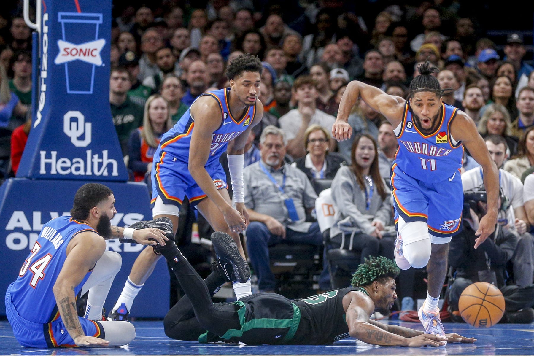 OKLAHOMA CITY, OKLAHOMA - JANUARY 03: Marcus Smart #36 of the Boston Celtics attempts to steal the ball from Isaiah Joe #11 of the Oklahoma City Thunder while Kenrich Williams #34 of the Oklahoma City Thunder and Aaron Wiggins #21 of the Oklahoma City Thunder watch during the second quarter at Paycom Center on January 03, 2023 in Oklahoma City, Oklahoma. NOTE TO USER: User expressly acknowledges and agrees that, by downloading and or using this photograph, User is consenting to the terms and conditions of the Getty Images License Agreement.  (Photo by Ian Maule/Getty Images)