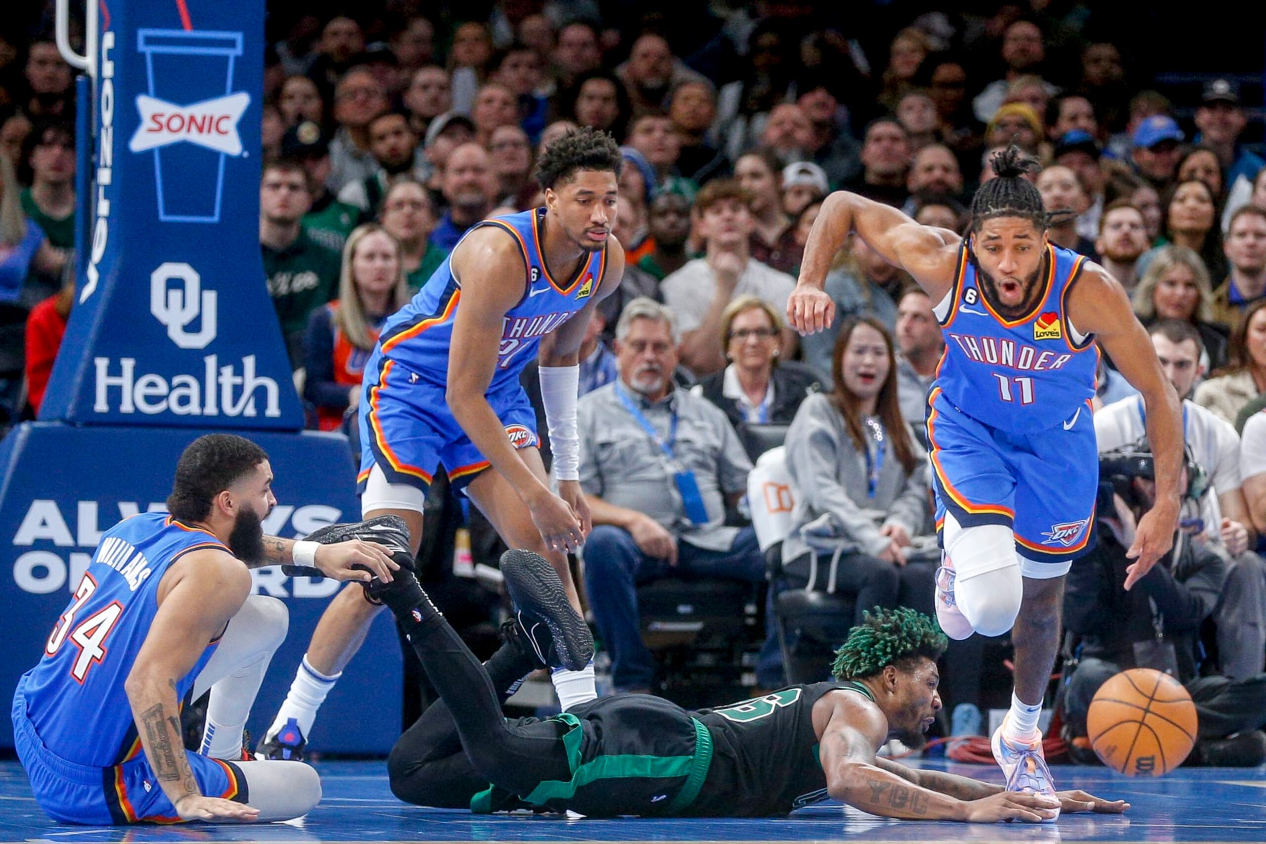 OKLAHOMA CITY, OKLAHOMA - JANUARY 03: Marcus Smart #36 of the Boston Celtics attempts to steal the ball from Isaiah Joe #11 of the Oklahoma City Thunder while Kenrich Williams #34 of the Oklahoma City Thunder and Aaron Wiggins #21 of the Oklahoma City Thunder watch during the second quarter at Paycom Center on January 03, 2023 in Oklahoma City, Oklahoma. NOTE TO USER: User expressly acknowledges and agrees that, by downloading and or using this photograph, User is consenting to the terms and conditions of the Getty Images License Agreement.  (Photo by Ian Maule/Getty Images)