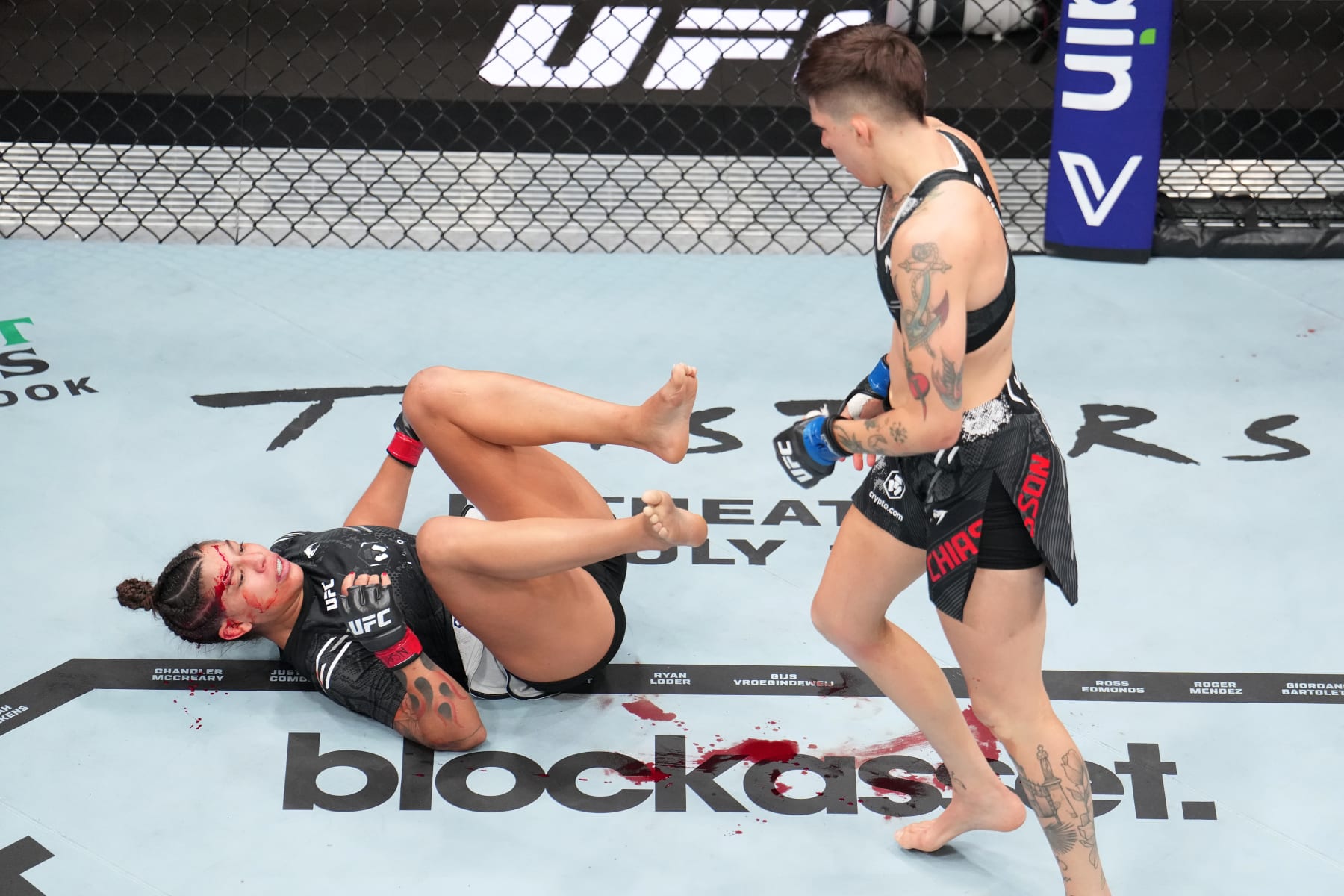 Macy Chiasson stands over Mayra Bueno Silva.