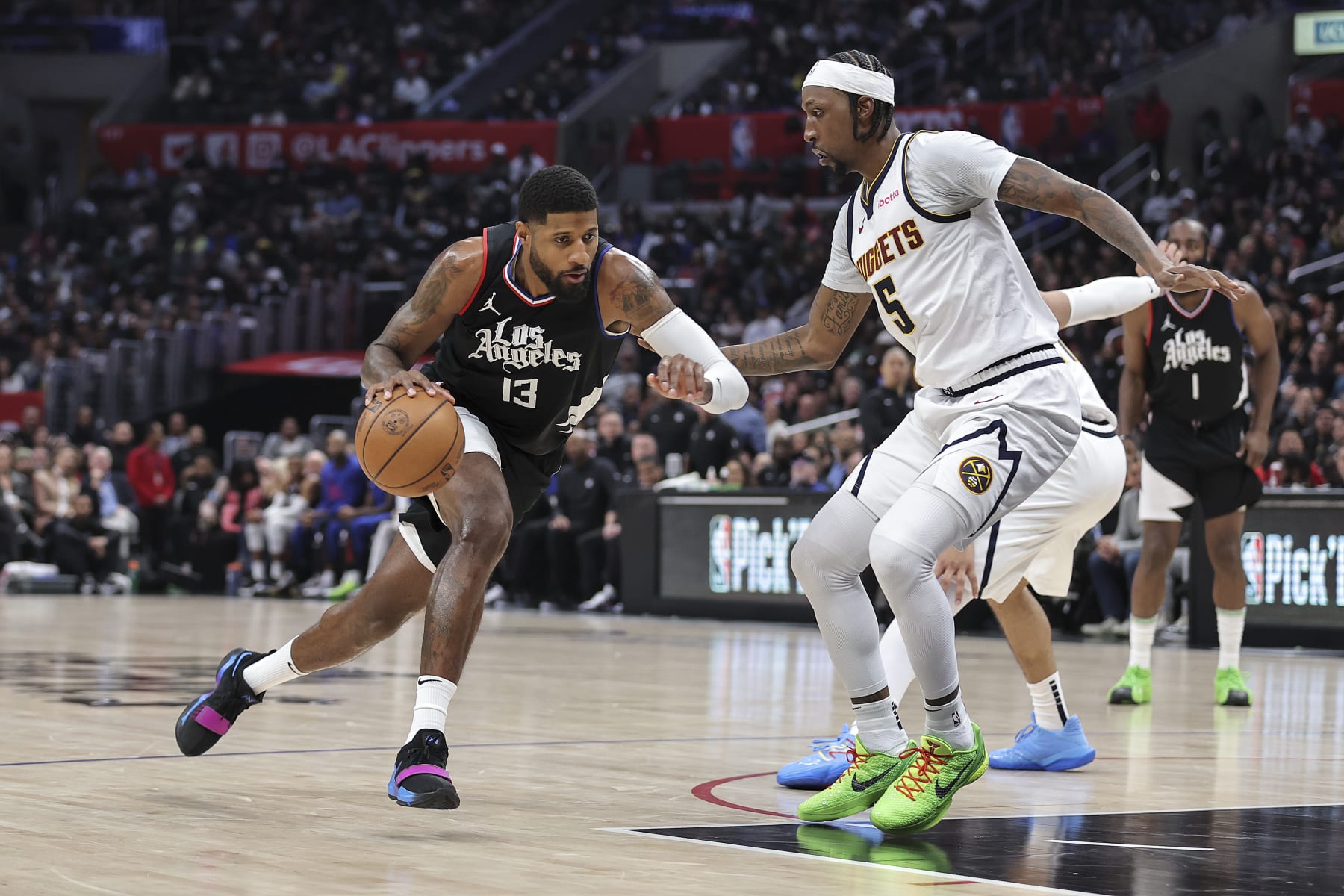 LOS ANGELES, CALIFORNIA - DECEMBER 06: Paul George #13 of the LA Clippers drives against Kentavious Caldwell-Pope #5 of the Denver Nuggets during the second half a game at Crypto.com Arena on December 06, 2023 in Los Angeles, California. NOTE TO USER: User expressly acknowledges and agrees that, by downloading and or using this photograph, User is consenting to the terms and conditions of the Getty Images License Agreement.  (Photo by Michael Owens/Getty Images)