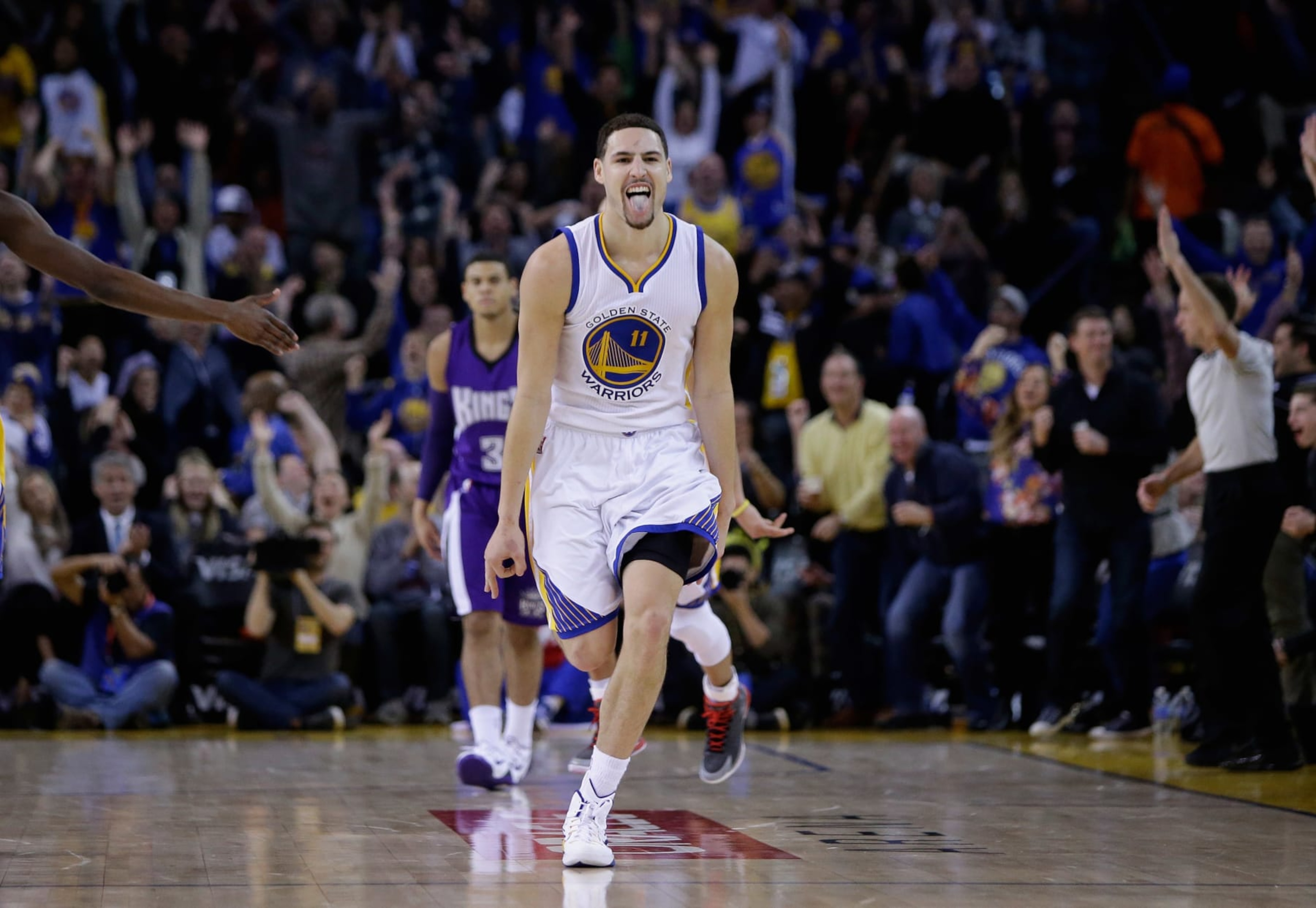 OAKLAND, CA - JANUARY 23:  Klay Thompson #11 of the Golden State Warriors reacts after he made a three-point basket in the third quarter of their game against the Sacramento Kings at ORACLE Arena on January 23, 2015 in Oakland, California. Thompson scored 37 points in the third quarter to set a NBA record. NOTE TO USER: User expressly acknowledges and agrees that, by downloading and or using this photograph, User is consenting to the terms and conditions of the Getty Images License Agreement.  (Photo by Ezra Shaw/Getty Images)