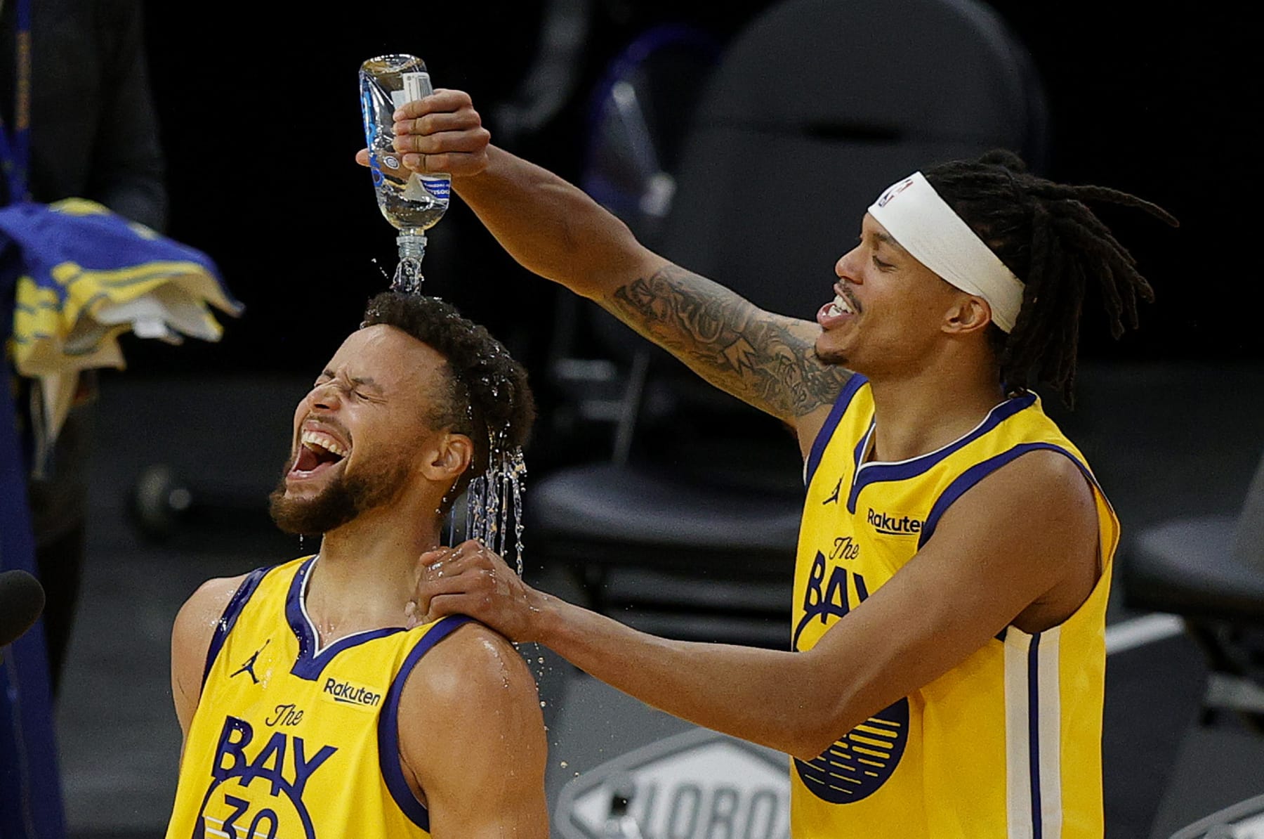 SAN FRANCISCO, CALIFORNIA - JANUARY 03:  Stephen Curry #30 of the Golden State Warriors is showered in water by Damion Lee #1 of the Golden State Warriors during a post-game interview after Curry scored a career-high 62 points against the Portland Trail Blazers at Chase Center on January 03, 2021 in San Francisco, California. NOTE TO USER: User expressly acknowledges and agrees that, by downloading and or using this photograph, User is consenting to the terms and conditions of the Getty Images License Agreement.  (Photo by Ezra Shaw/undefined)