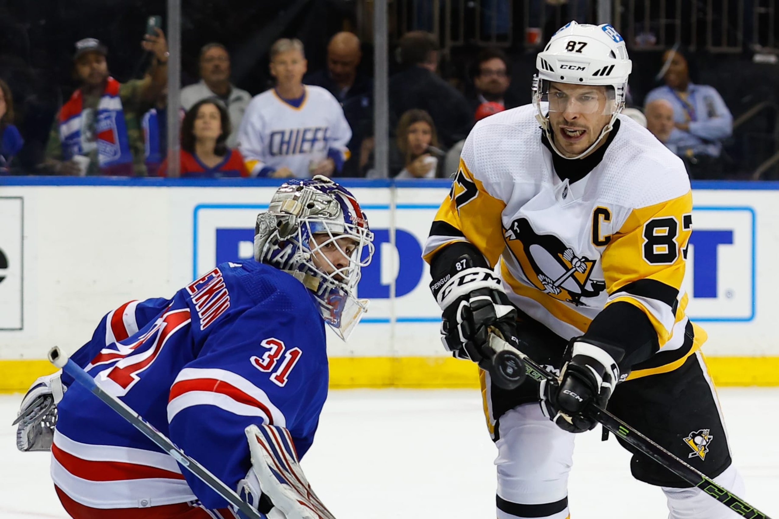NEW YORK, NY - MARCH 18:  Sidney Crosby #87 of the Pittsburgh Penguins deflects the puck off the post against Igor Shesterkin #31 of the New York Rangers on March 18, 2023 at Madison Square Garden in New York, New York.  (Photo by Rich Graessle/Getty Images)