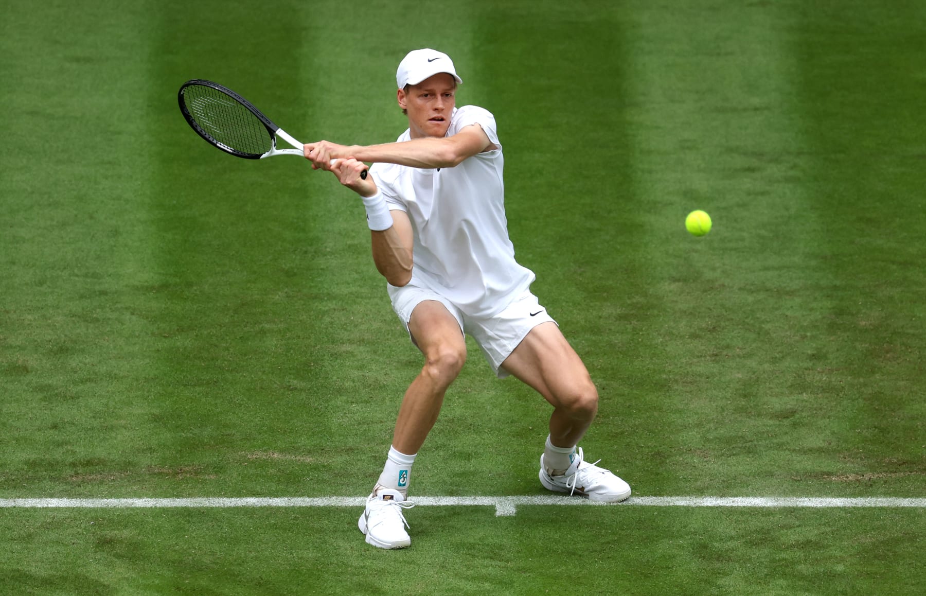 LONDON, ENGLAND - JULY 01: Jannick Sinner of Italy plays a backhand against Yannick Hanfmann of Germany in the Gentlemen's Singles first round match during day one of The Championships Wimbledon 2024 at All England Lawn Tennis and Croquet Club on July 01, 2024 in London, England. (Photo by Julian Finney/Getty Images)