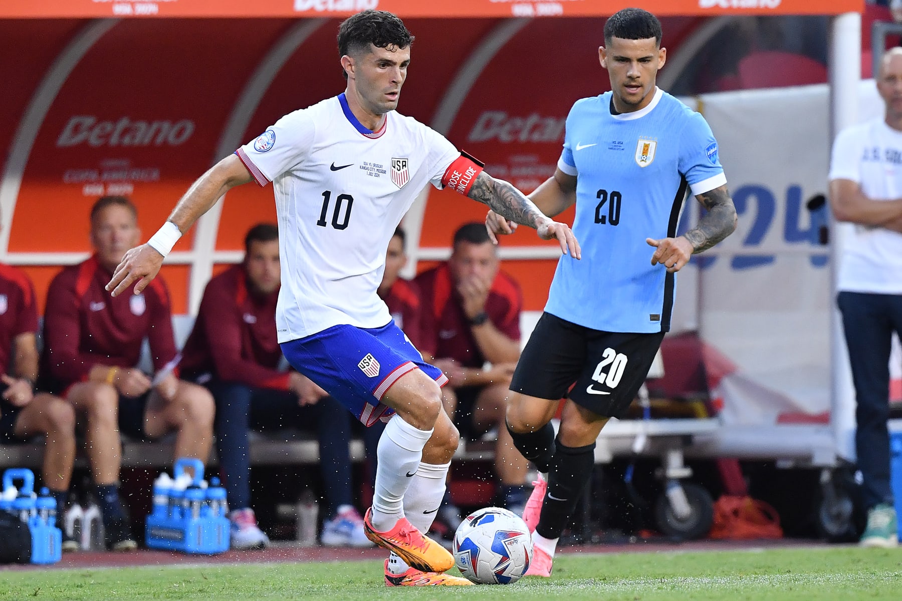 KANSAS CITY, MISSOURI - JULY 01: Christian Pulisic #10 of the United States is marked by Maximiliano Araujo #20 of Uruguay during the first half at GEHA Field at Arrowhead Stadium on July 01, 2024 in Kansas City, Missouri. (Photo by Bill Barrett/ISI Photos/USSF/Getty Images for USSF)