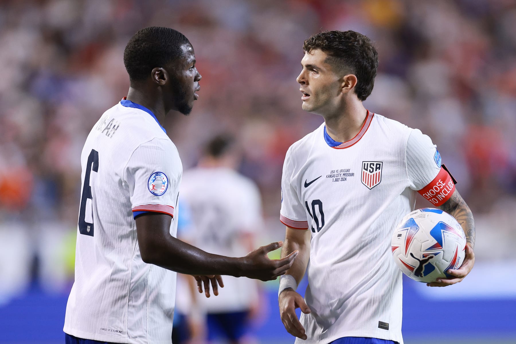 KANSAS CITY, MISSOURI - JULY 01: Christian Pulisic #10 of the United States talks with Yunus Musah #6 during the second half against Uruguay at GEHA Field at Arrowhead Stadium on July 01, 2024 in Kansas City, Missouri. (Photo by Carmen Mandato/USSF/Getty Images for USSF)