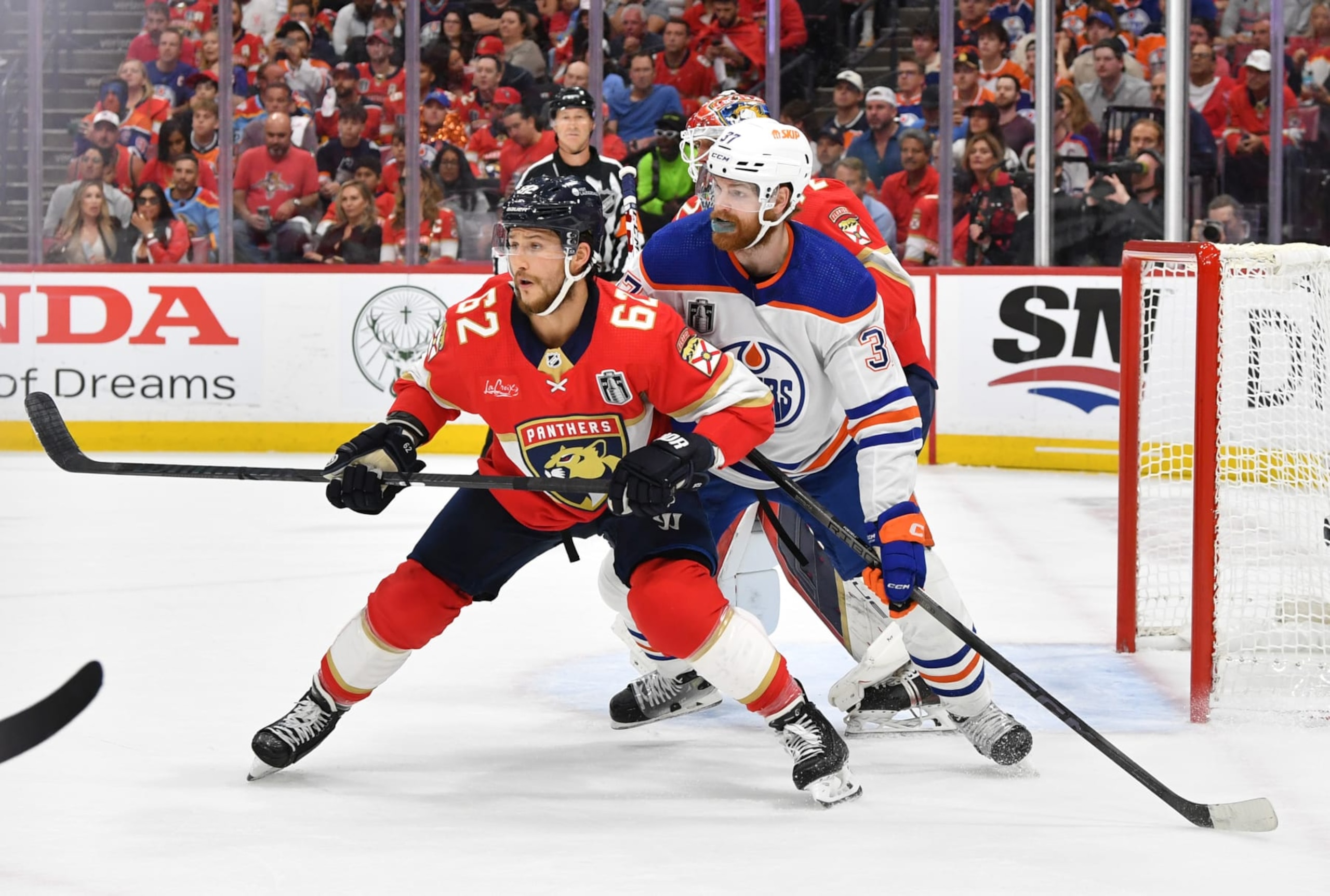 SUNRISE, FLORIDA - JUNE 24: Brandon Montour #62 of the Florida Panthers defends the play of Warren Foegele #37 of the Edmonton Oilers in front of the Panthers net during the first period of Game Seven of the 2024 Stanley Cup Final between the Edmonton Oilers and the Florida Panthers at Amerant Bank Arena on June 24, 2024 in Sunrise, Florida. (Photo by Andy Devlin/NHLI via Getty Images) SUNRISE, FLORIDA - JUNE 24: Brandon Montour #62 of the Florida Panthers defends the play of Warren Foegele #37 of the Edmonton Oilers in front of the Panthers net during the first period of Game Seven of the 2024 Stanley Cup Final between the Edmonton Oilers and the Florida Panthers at Amerant Bank Arena on June 24, 2024 in Sunrise, Florida. (Photo by Andy Devlin/NHLI via Getty Images)
