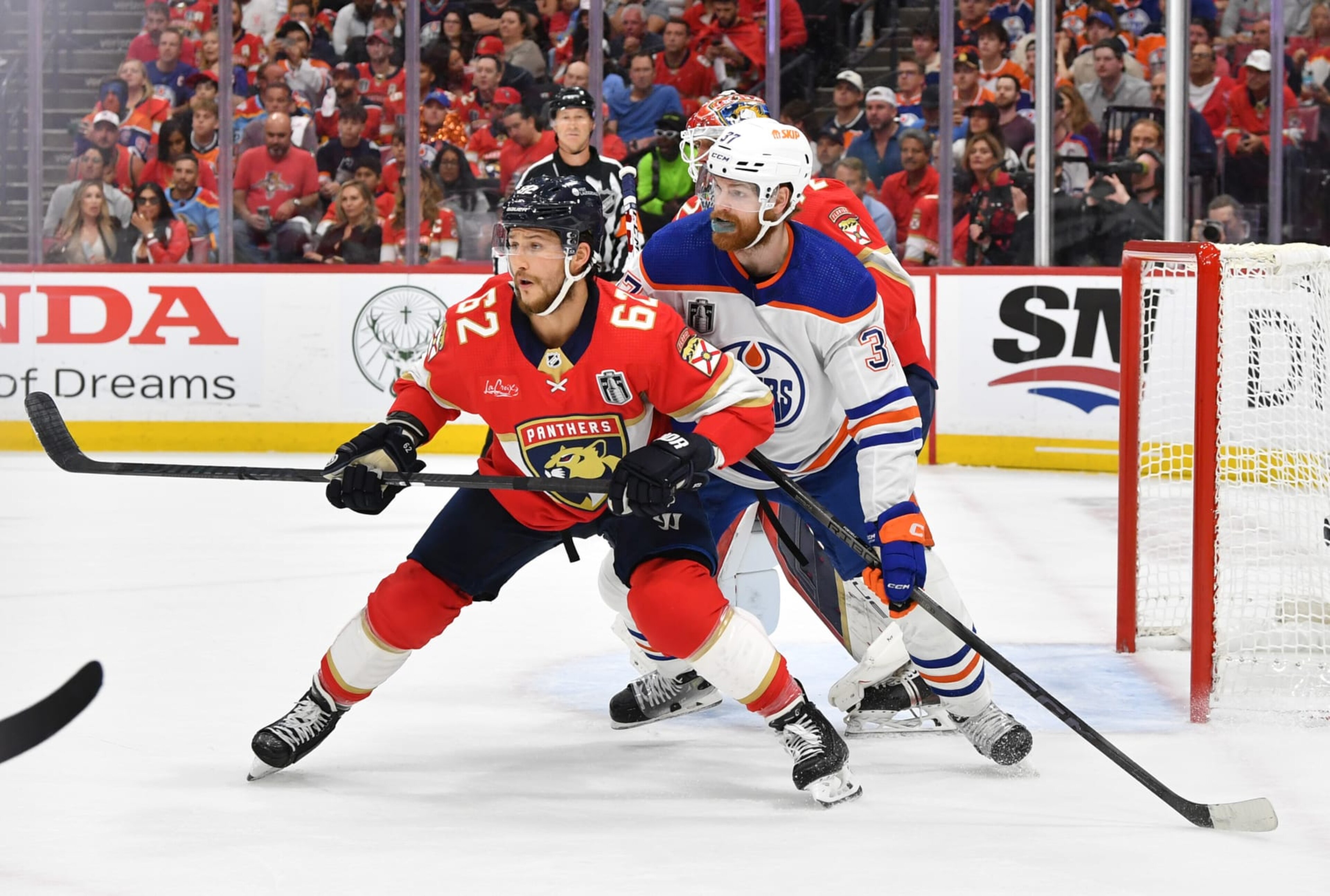 SUNRISE, FLORIDA - JUNE 24: Brandon Montour #62 of the Florida Panthers defends the play of Warren Foegele #37 of the Edmonton Oilers in front of the Panthers net during the first period of Game Seven of the 2024 Stanley Cup Final between the Edmonton Oilers and the Florida Panthers at Amerant Bank Arena on June 24, 2024 in Sunrise, Florida. (Photo by Andy Devlin/NHLI via Getty Images)