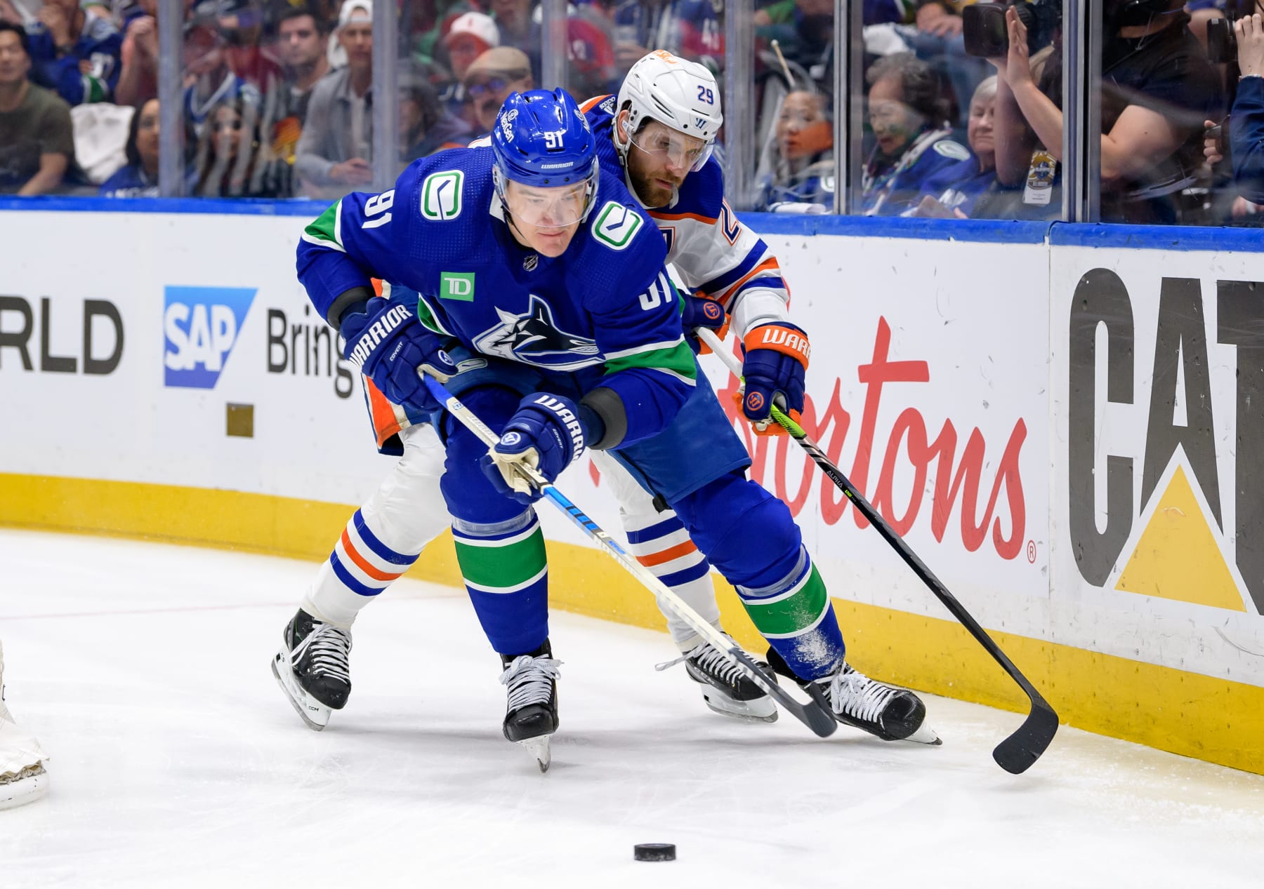 VANCOUVER, CANADA - MAY 20: Leon Draisaitl #29 of the Edmonton Oilers checks Nikita Zadorov #91 of the Vancouver Canucks during the first period in Game Seven of the Second Round of the 2024 Stanley Cup Playoffs at Rogers Arena on May 20, 2024 in Vancouver, British Columbia, Canada. (Photo by Derek Cain/Getty Images)