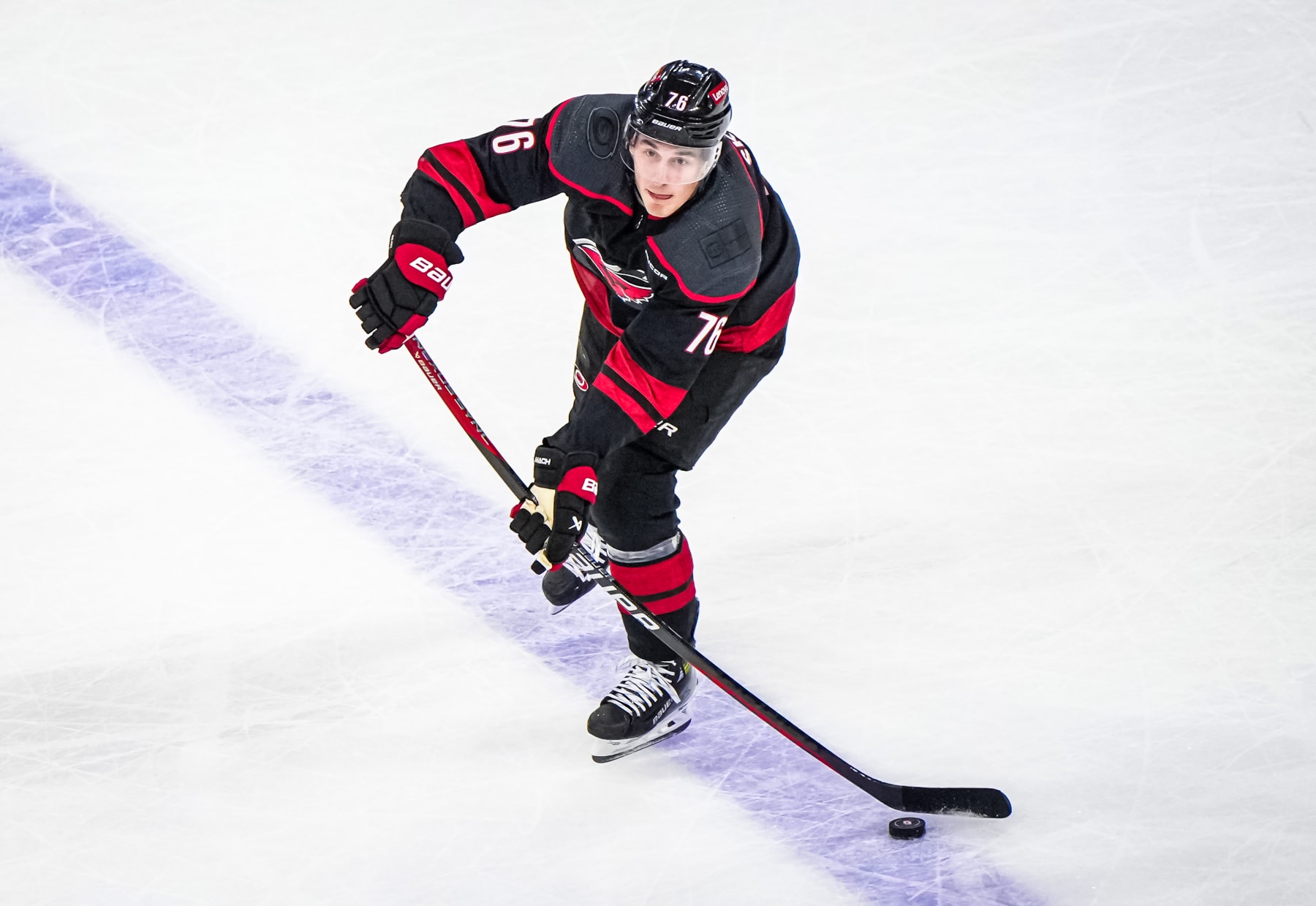 RALEIGH, NORTH CAROLINA - APRIL 20: Brady Skjei #76 of the Carolina Hurricanes passes the puck during the first period against the New York Islanders in Game One of the First Round of the 2024 Stanley Cup Playoffs at PNC Arena on April 7, 2024 in Raleigh, North Carolina. (Photo by Cato Cataldo/NHLI via Getty Images)