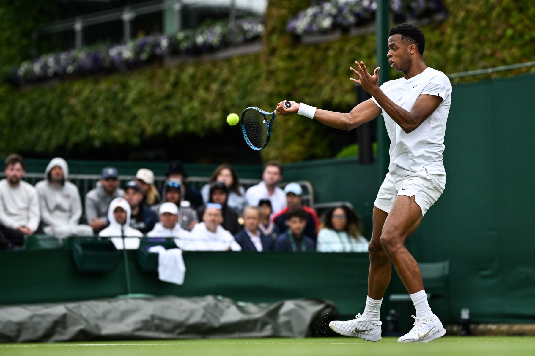 France's Giovanni Mpetshi Perricard returns the ball to USA's Sebastian Korda during their men's singles tennis match on the second day of the 2024 Wimbledon Championships at The All England Lawn Tennis and Croquet Club in Wimbledon, southwest London, on July 2, 2024. (Photo by Ben Stansall / AFP) / RESTRICTED TO EDITORIAL USE (Photo by BEN STANSALL/AFP via Getty Images)