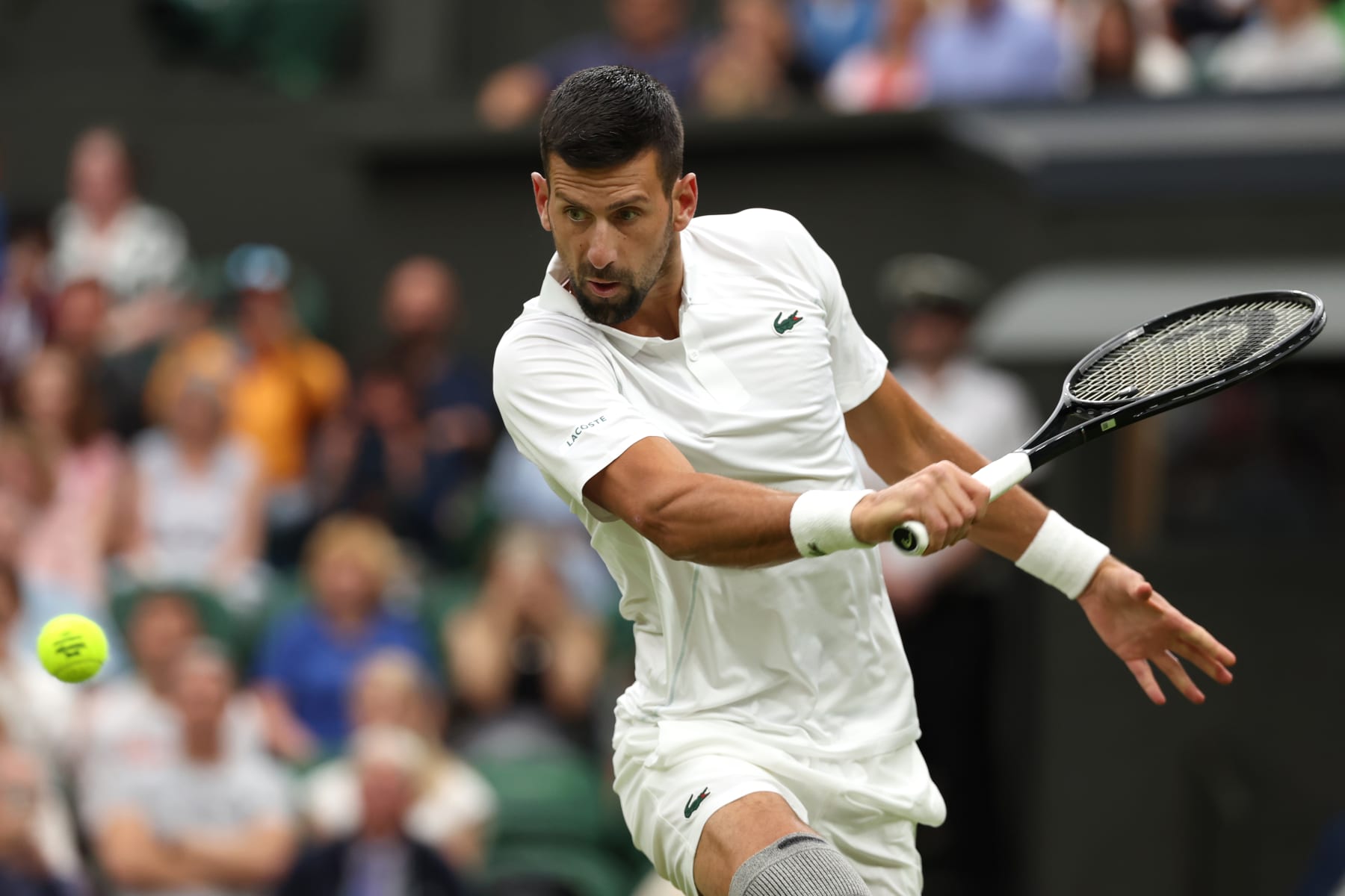 LONDON, ENGLAND - JULY 02: Novak Djokovic of Serbia plays a backhand against Vit Kopriva of Czechia of his Gentlemen's Singles first round match during day two of The Championships Wimbledon 2024 at All England Lawn Tennis and Croquet Club on July 02, 2024 in London, England. (Photo by Sean M. Haffey/Getty Images)