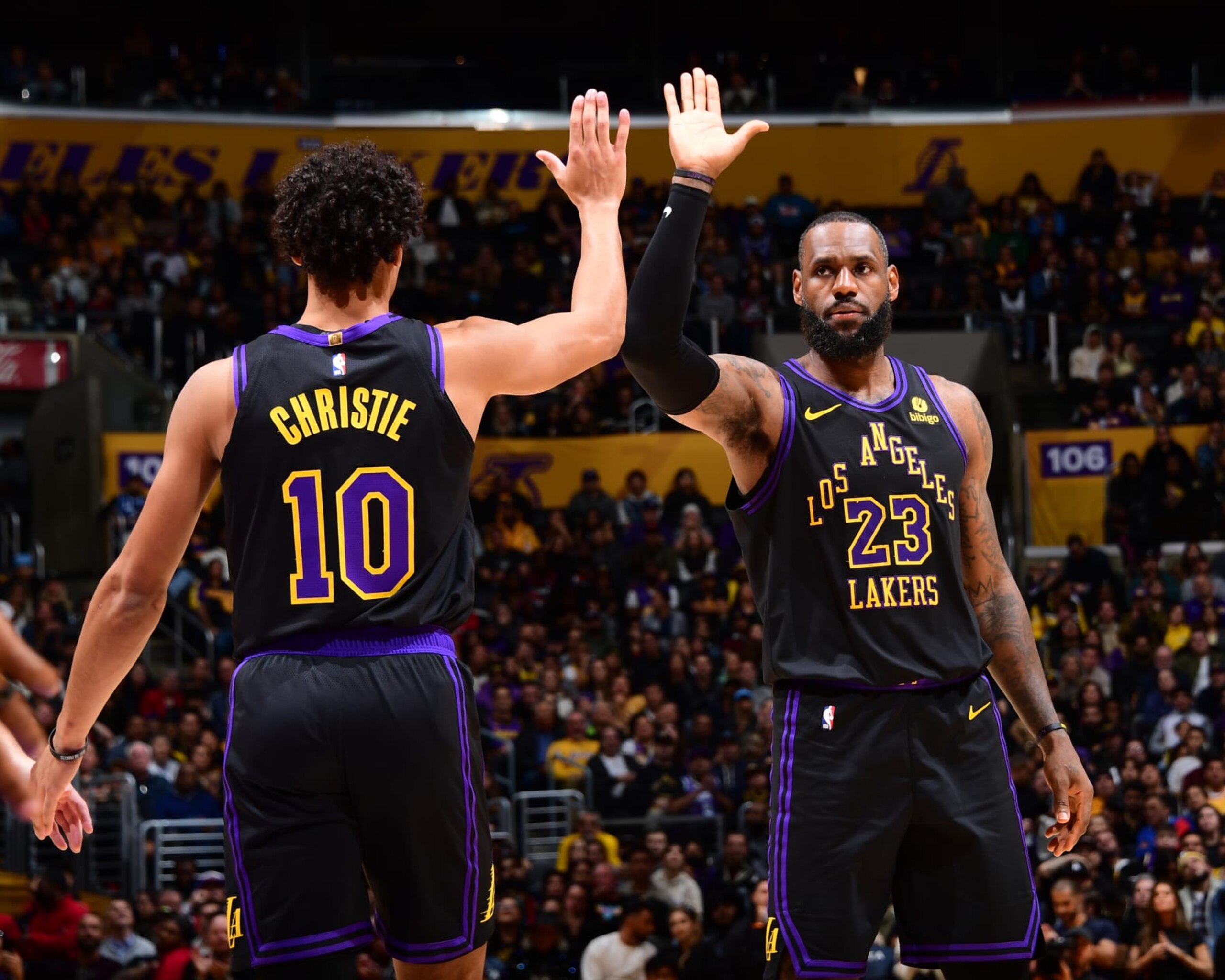 LOS ANGELES, CA - JANUARY 9: Max Christie #10 high fives LeBron James #23 of the Los Angeles Lakers during the game against the Toronto Raptors on January 9, 2024 at Crypto.Com Arena in Los Angeles, California. NOTE TO USER: User expressly acknowledges and agrees that, by downloading and/or using this Photograph, user is consenting to the terms and conditions of the Getty Images License Agreement. Mandatory Copyright Notice: Copyright 2024 NBAE (Photo by Adam Pantozzi/NBAE via Getty Images)