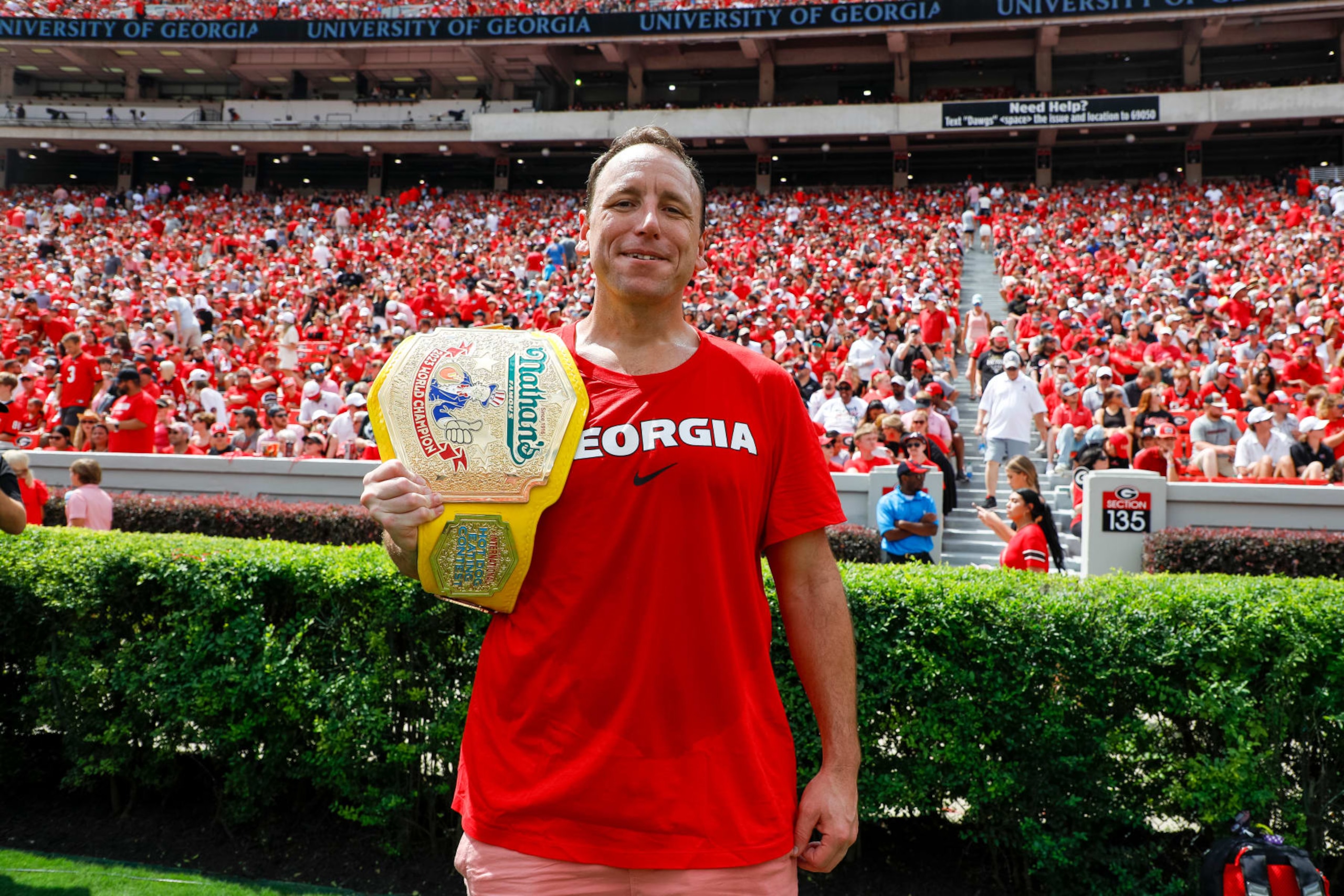 ATHENS, GEORGIA - SEPTEMBER 9: Competitive eater Joey Chestnut poses with his mustard yellow championship belt during a game between the Georgia Bulldogs and the Ball State Cardinals at Sanford Stadium on September 9, 2023 in Athens, Georgia. (Photo by Brandon Sloter/Image Of Sport/Getty Images)