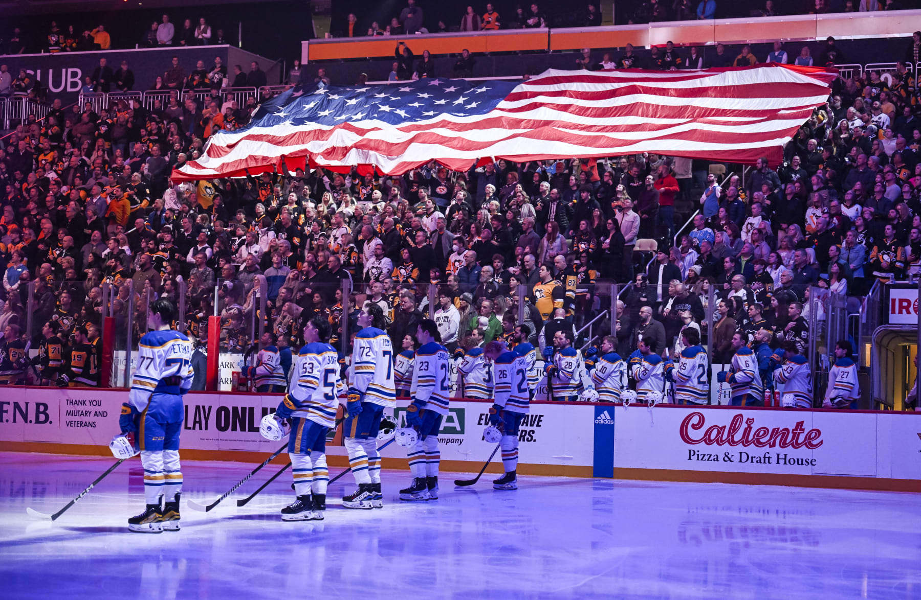 PITTSBURGH, PA - NOVEMBER 11: A larger American flag is displayed in the crowd during the National Anthem prior to the first period in the NHL game between the Pittsburgh Penguins and the Buffalo Sabres on November 11, 2023, at PPG Paints Arena in Pittsburgh, PA. (Photo by Jeanine Leech/Icon Sportswire via Getty Images)