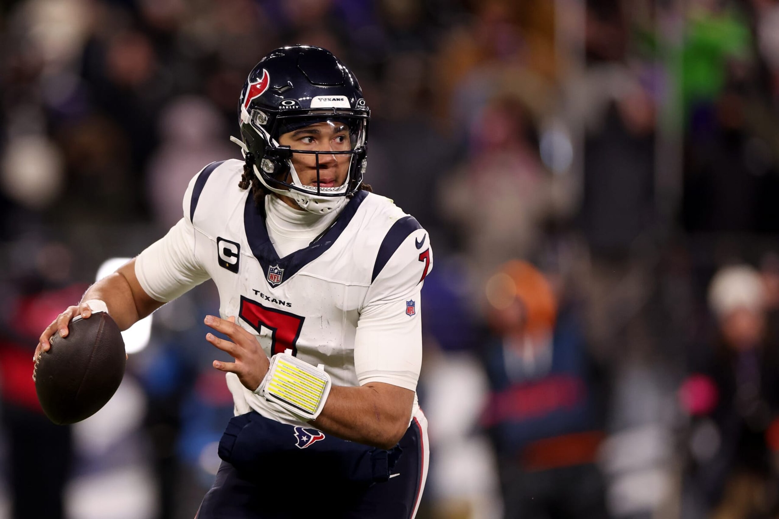 BALTIMORE, MARYLAND - JANUARY 20: Quarterback C.J. Stroud #7 of the Houston Texans rolls out to pass against the Baltimore Ravens in the second half at M&T Bank Stadium on January 20, 2024 in Baltimore, Maryland. (Photo by Rob Carr/Getty Images)