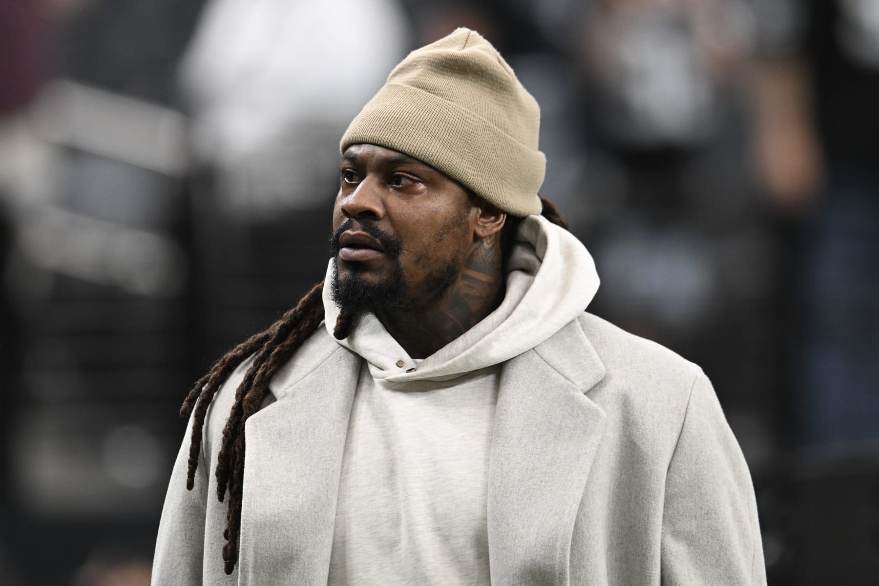 LAS VEGAS, NEVADA - OCTOBER 09: Former NFL player Marshawn Lynch walks the sideline before the Las Vegas Raiders and Green Bay Packers game at Allegiant Stadium on October 09, 2023 in Las Vegas, Nevada. The Raiders defeated the Packers 17-13. (Photo by Candice Ward/Getty Images)