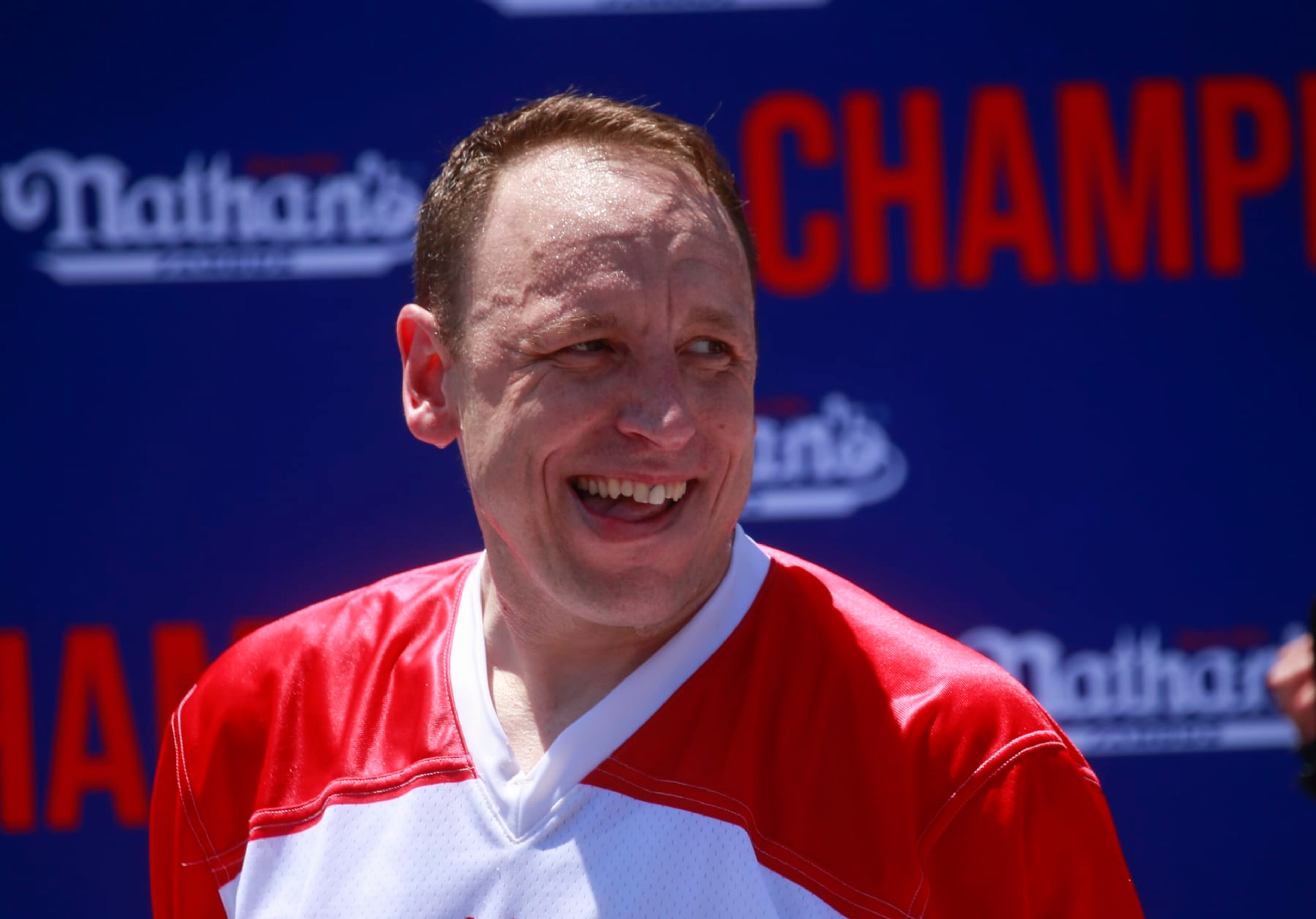 NEW YORK, NY - JULY 04: Joey Chestnut reacts after he won first place, eating 63 hot dogs in 10 minutes, during the 2022 Nathan's Famous Fourth of July International Hot Dog Eating Contest on July 4, 2022 at Coney Island in the Brooklyn borough of New York City. The contest, which has happened every year since 1972, has returned in front of Nathan's Famous on Surf Avenue this year. (Photo by Kena Betancur/Getty Images) NEW YORK, NY - JULY 04: Joey Chestnut reacts after he won first place, eating 63 hot dogs in 10 minutes, during the 2022 Nathan's Famous Fourth of July International Hot Dog Eating Contest on July 4, 2022 at Coney Island in the Brooklyn borough of New York City. The contest, which has happened every year since 1972, has returned in front of Nathan's Famous on Surf Avenue this year. (Photo by Kena Betancur/Getty Images)