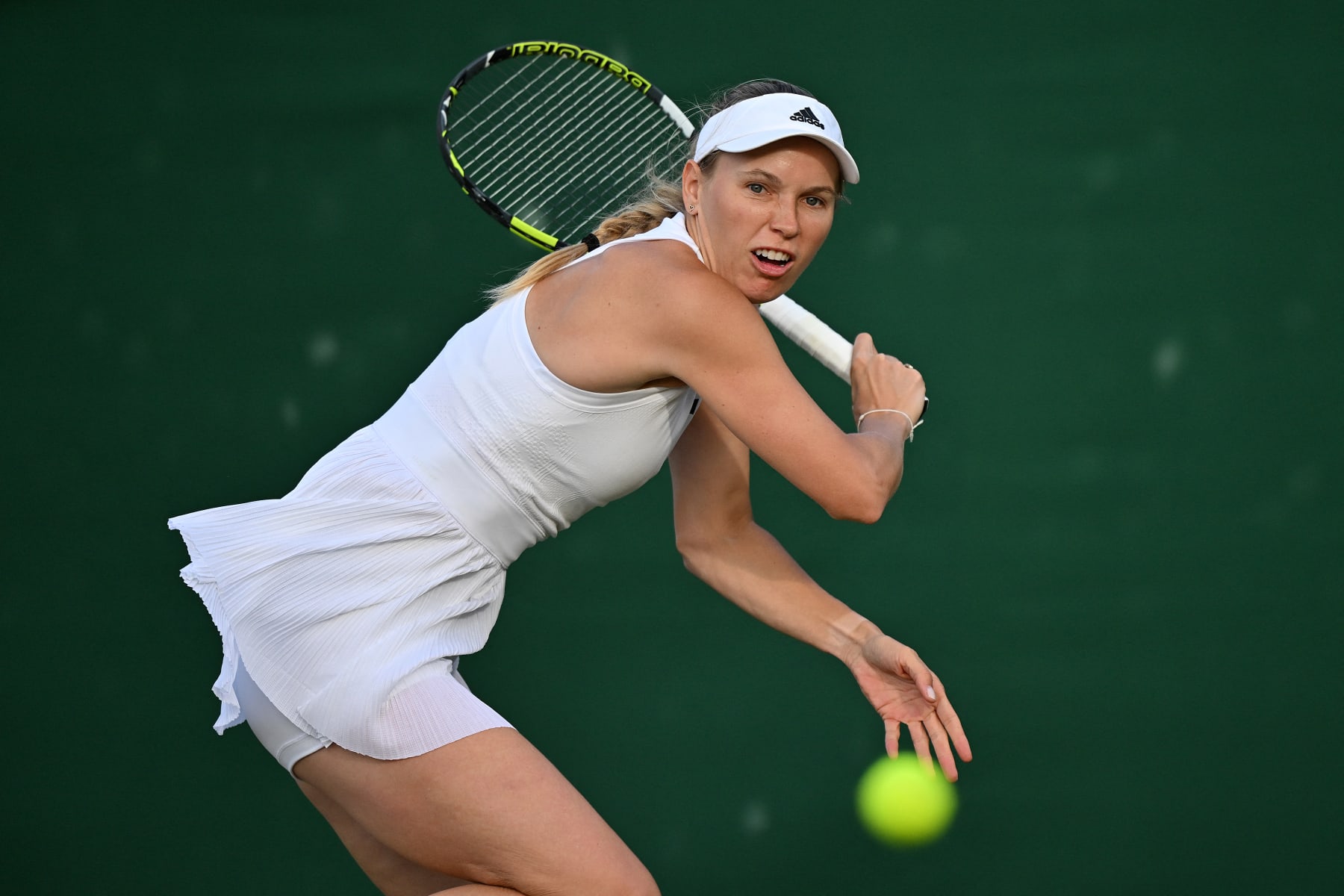 Denmark's Caroline Wozniacki returns against Canada's Leylah Fernandez during their women's second round singles tennis match on the fourth day of the 2024 Wimbledon Championships at The All England Lawn Tennis and Croquet Club in Wimbledon, southwest London, on July 4, 2024. (Photo by ANDREJ ISAKOVIC / AFP) / RESTRICTED TO EDITORIAL USE (Photo by ANDREJ ISAKOVIC/AFP via Getty Images)