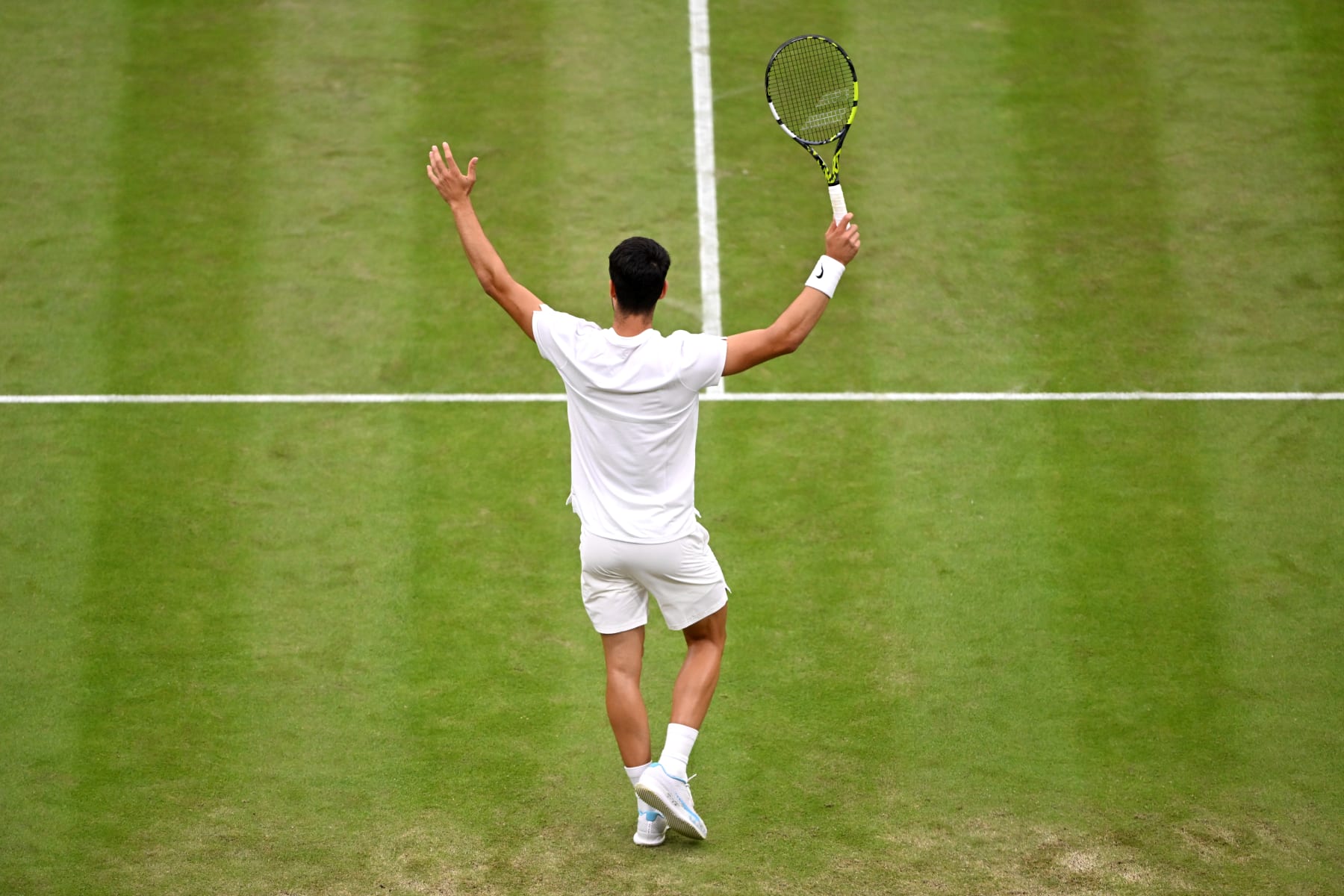 LONDON, ENGLAND - JULY 05: Carlos Alcaraz of Spain celebrates winning match point against Frances Tiafoe of United States in his Gentlemen's Singles third round match during day five of The Championships Wimbledon 2024 at All England Lawn Tennis and Croquet Club on July 05, 2024 in London, England. (Photo by Mike Hewitt/Getty Images)