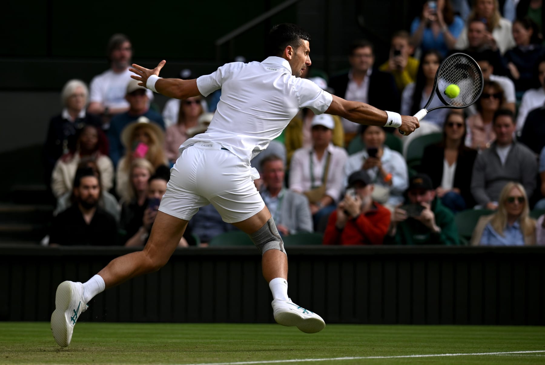 LONDON, ENGLAND - JULY 06: Novak Djokovic of Serbia plays a backhand against Alexei Popyrin of Australia in the Gentlemen's Singles third round match during day six of The Championships Wimbledon 2024 at All England Lawn Tennis and Croquet Club on July 06, 2024 in London, England. (Photo by Mike Hewitt/Getty Images)