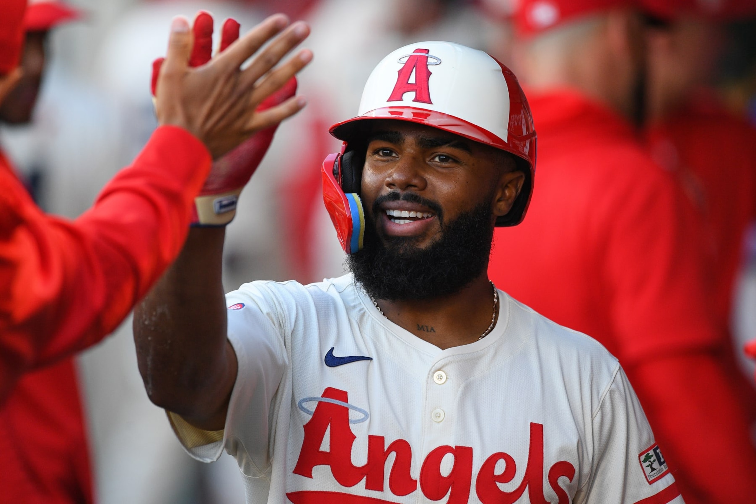 ANAHEIM, CA - JUNE 24: Los Angeles Angels third baseman Luis Rengifo (2) gets a high five after scoring a run during the MLB game between the Oakland Athletics and the Los Angeles Angels of Anaheim on June 24, 2024 at Angel Stadium of Anaheim in Anaheim, CA. (Photo by Brian Rothmuller/Icon Sportswire via Getty Images)