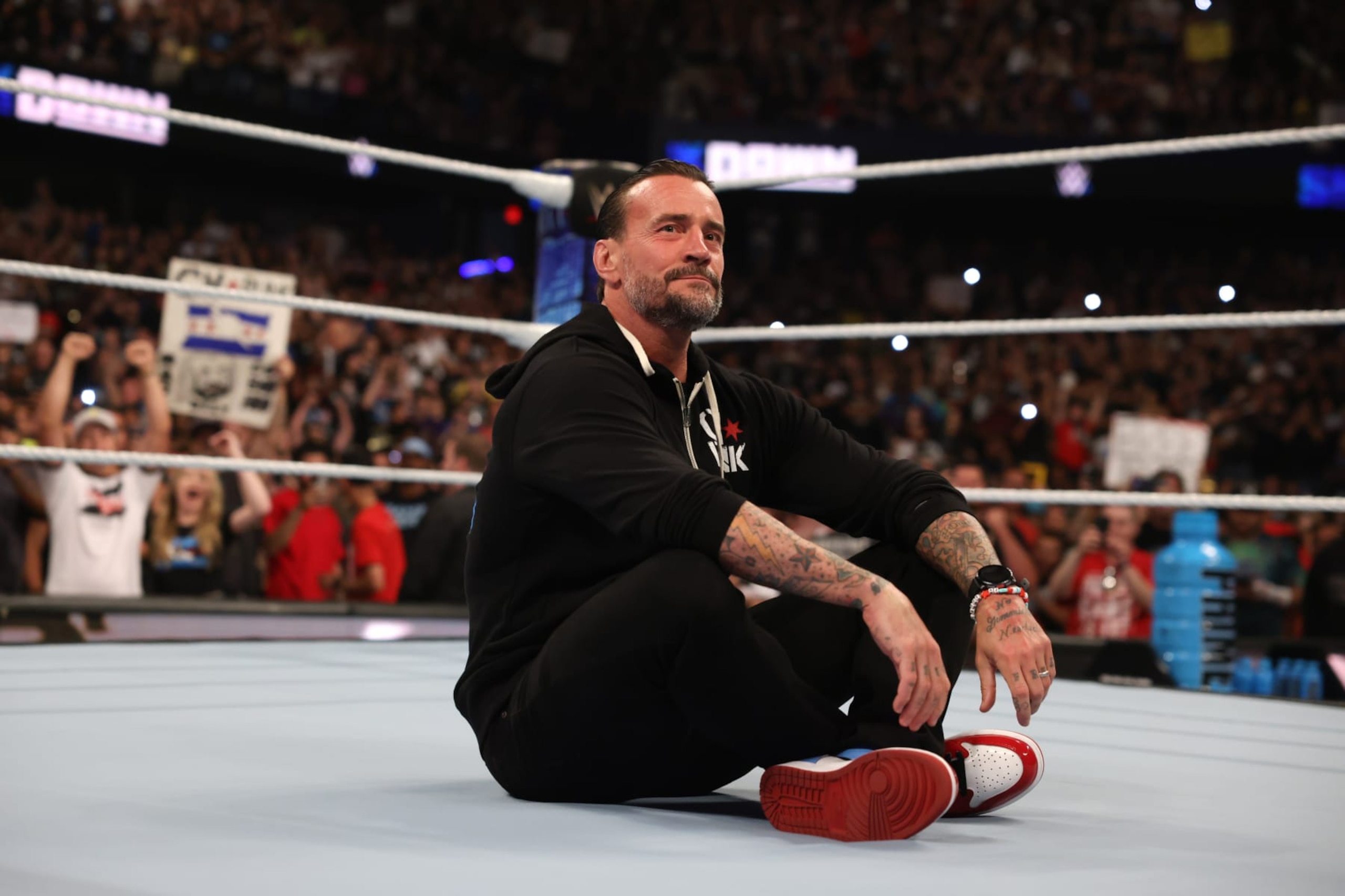 ROSEMONT, ILLINOIS - JUNE 21: CM Punk sits in the center of the ring and looks on during WWE SmackDown at Allstate Arena on June 21, 2024 in Rosemont, Illinois. (Photo by WWE/Getty Images) ROSEMONT, ILLINOIS - JUNE 21: CM Punk sits in the center of the ring and looks on during WWE SmackDown at Allstate Arena on June 21, 2024 in Rosemont, Illinois. (Photo by WWE/Getty Images)