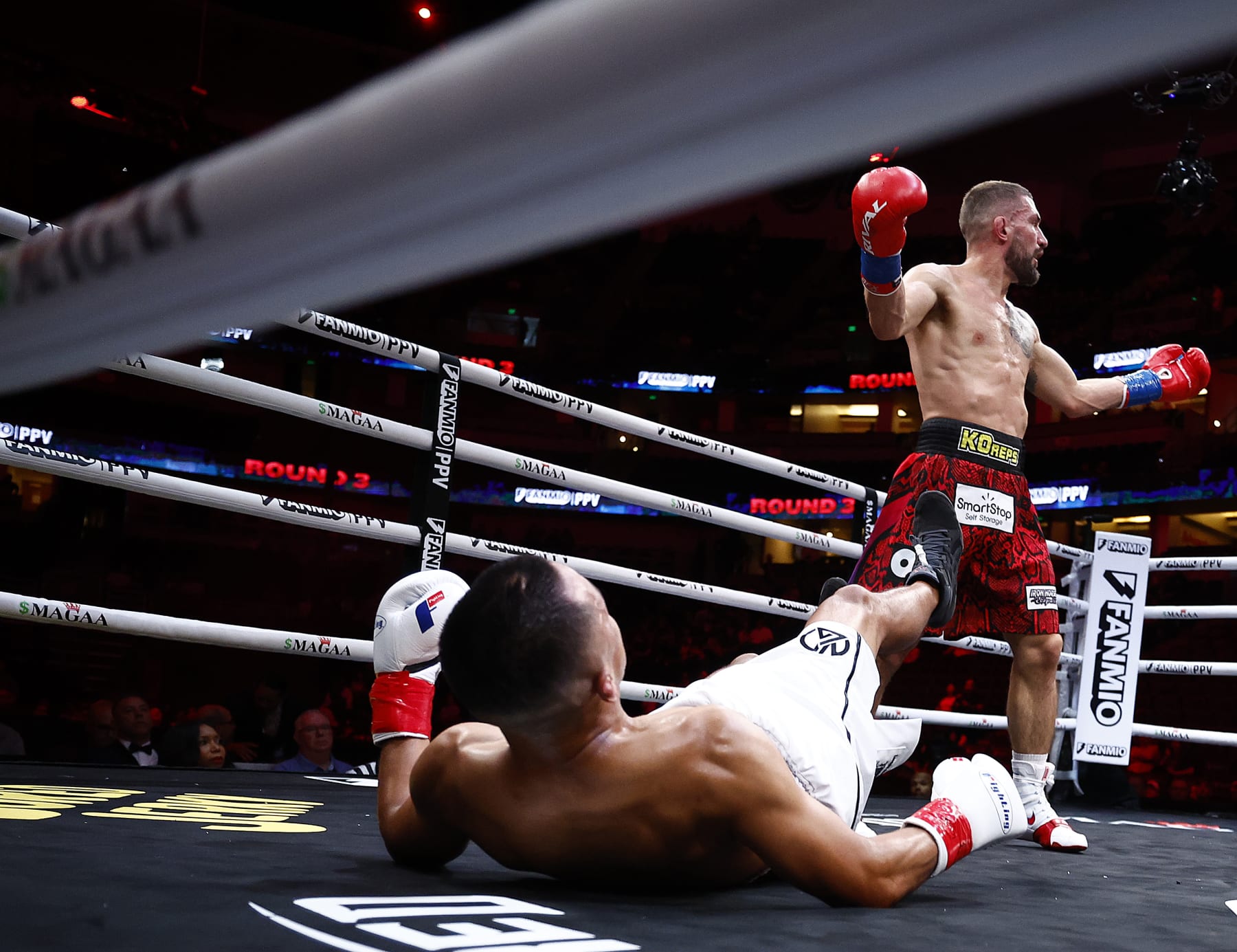 ANAHEIM, CALIFORNIA - JULY 06: (L-R) Jose Aguayo falls against Bryce Logan during round four of their junior middleweights fight at Honda Center on July 06, 2024 in Anaheim, California. (Photo by Ronald Martinez/Getty Images)