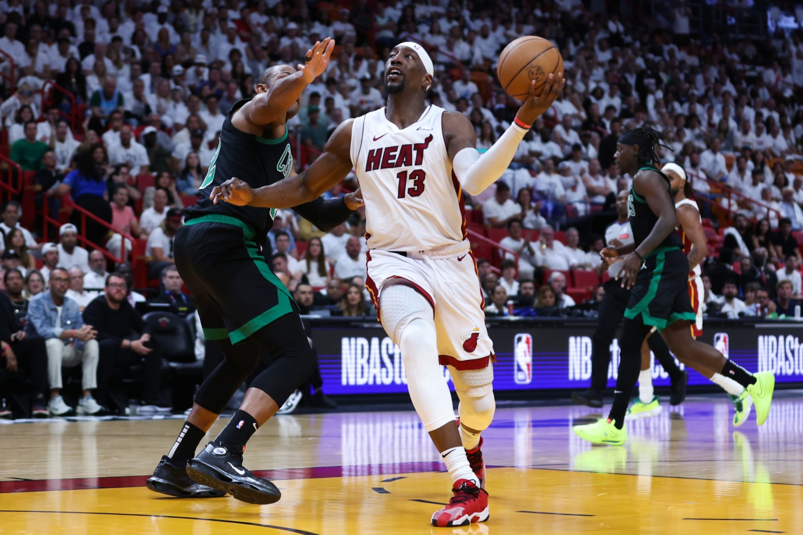 MIAMI, FLORIDA - APRIL 29: Bam Adebayo #13 of the Miami Heat goes to the basket past Al Horford #42 of the Boston Celtics during the fourth quarter in game four of the Eastern Conference First Round Playoffs at Kaseya Center on April 29, 2024 in Miami, Florida. NOTE TO USER: User expressly acknowledges and agrees that, by downloading and or using this photograph, User is consenting to the terms and conditions of the Getty Images License Agreement. (Photo by Megan Briggs/Getty Images) MIAMI, FLORIDA - APRIL 29: Bam Adebayo #13 of the Miami Heat goes to the basket past Al Horford #42 of the Boston Celtics during the fourth quarter in game four of the Eastern Conference First Round Playoffs at Kaseya Center on April 29, 2024 in Miami, Florida. NOTE TO USER: User expressly acknowledges and agrees that, by downloading and or using this photograph, User is consenting to the terms and conditions of the Getty Images License Agreement. (Photo by Megan Briggs/Getty Images)