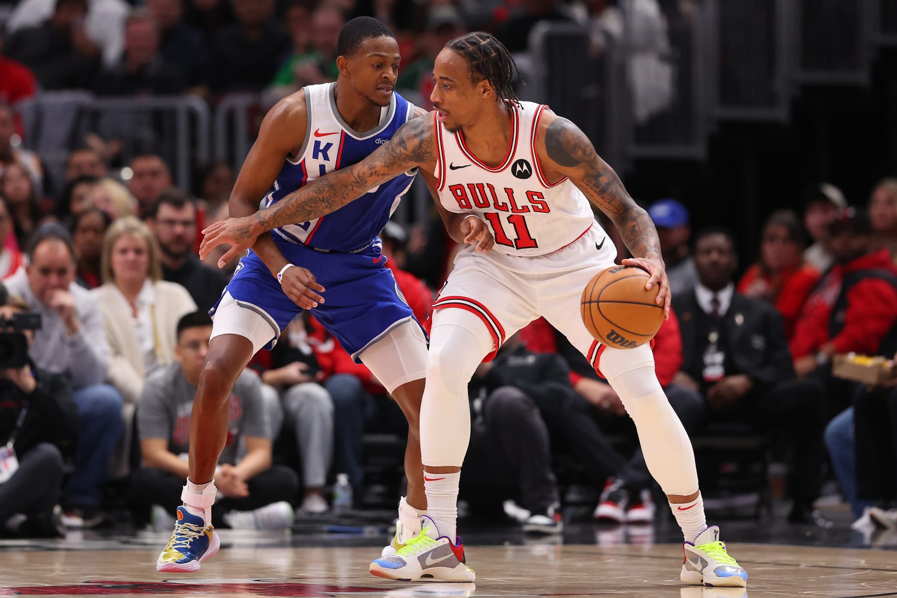 CHICAGO, ILLINOIS - FEBRUARY 03: DeMar DeRozan #11 of the Chicago Bulls is defended by De'Aaron Fox #5 of the Sacramento Kings during the first half at the United Center on February 03, 2024 in Chicago, Illinois. NOTE TO USER: User expressly acknowledges and agrees that, by downloading and or using this photograph, User is consenting to the terms and conditions of the Getty Images License Agreement.  (Photo by Michael Reaves/Getty Images)