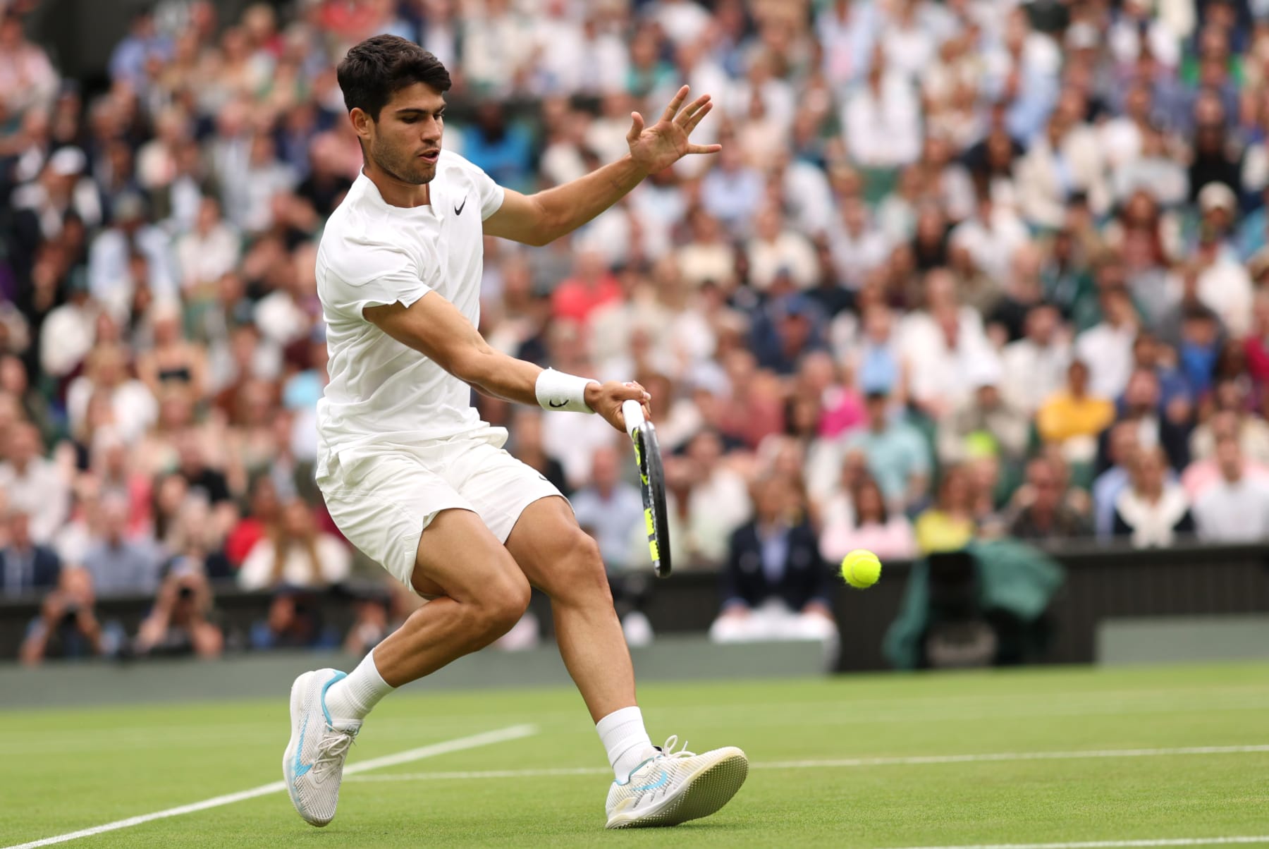 LONDON, ENGLAND - JULY 07: Carlos Alcaraz of Spain plays a forehand against Ugo Humbert of France in his Gentleman's Singles fourth round match during day seven of The Championships Wimbledon 2024 at All England Lawn Tennis and Croquet Club on July 07, 2024 in London, England. (Photo by Clive Brunskill/Getty Images)