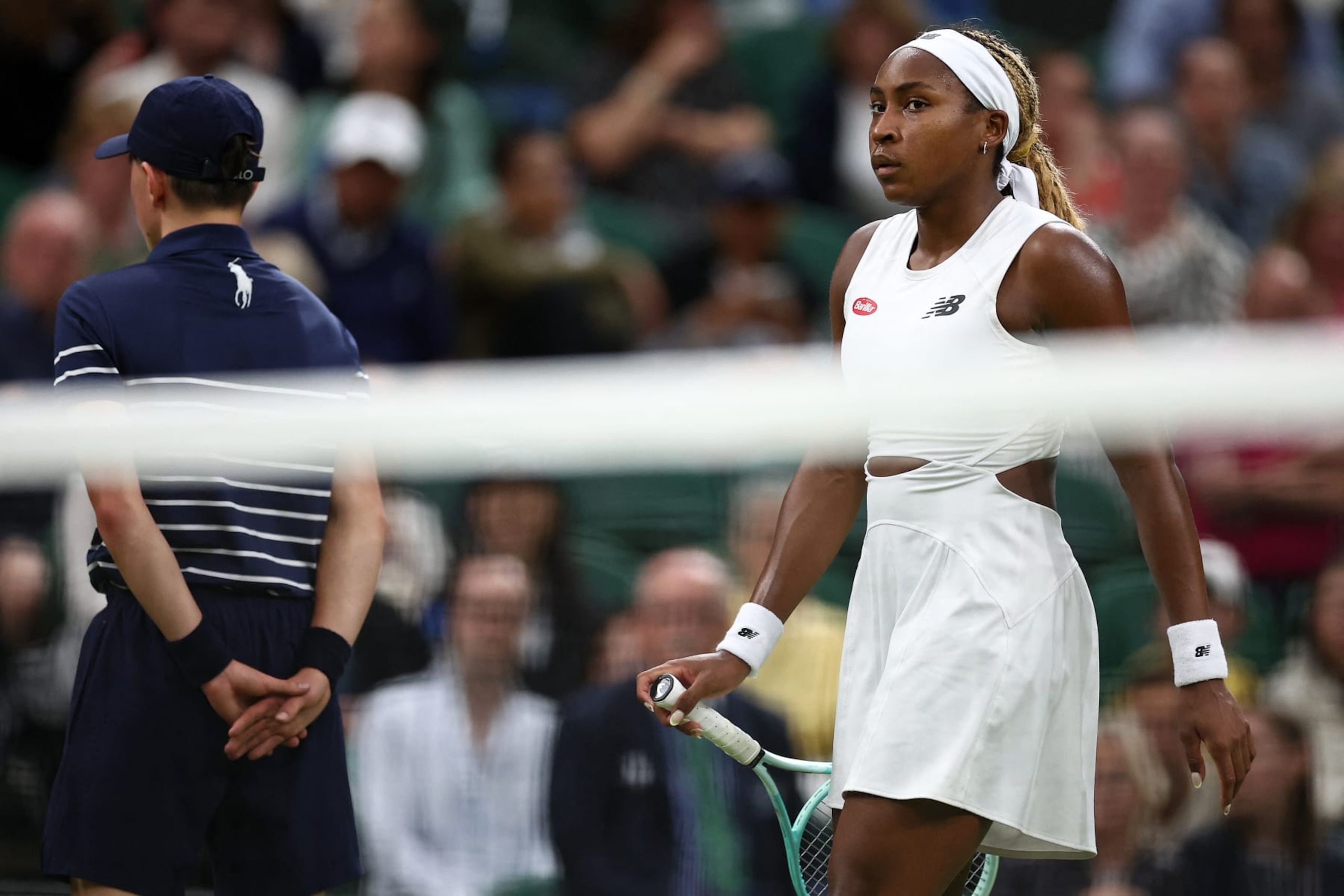 US player Coco Gauff reacts as she changes ends against USA's Emma Navarro during their women's singles fourth round tennis match on the seventh day of the 2024 Wimbledon Championships at The All England Lawn Tennis and Croquet Club in Wimbledon, southwest London, on July 7, 2024. (Photo by HENRY NICHOLLS / AFP) / RESTRICTED TO EDITORIAL USE (Photo by HENRY NICHOLLS/AFP via Getty Images)