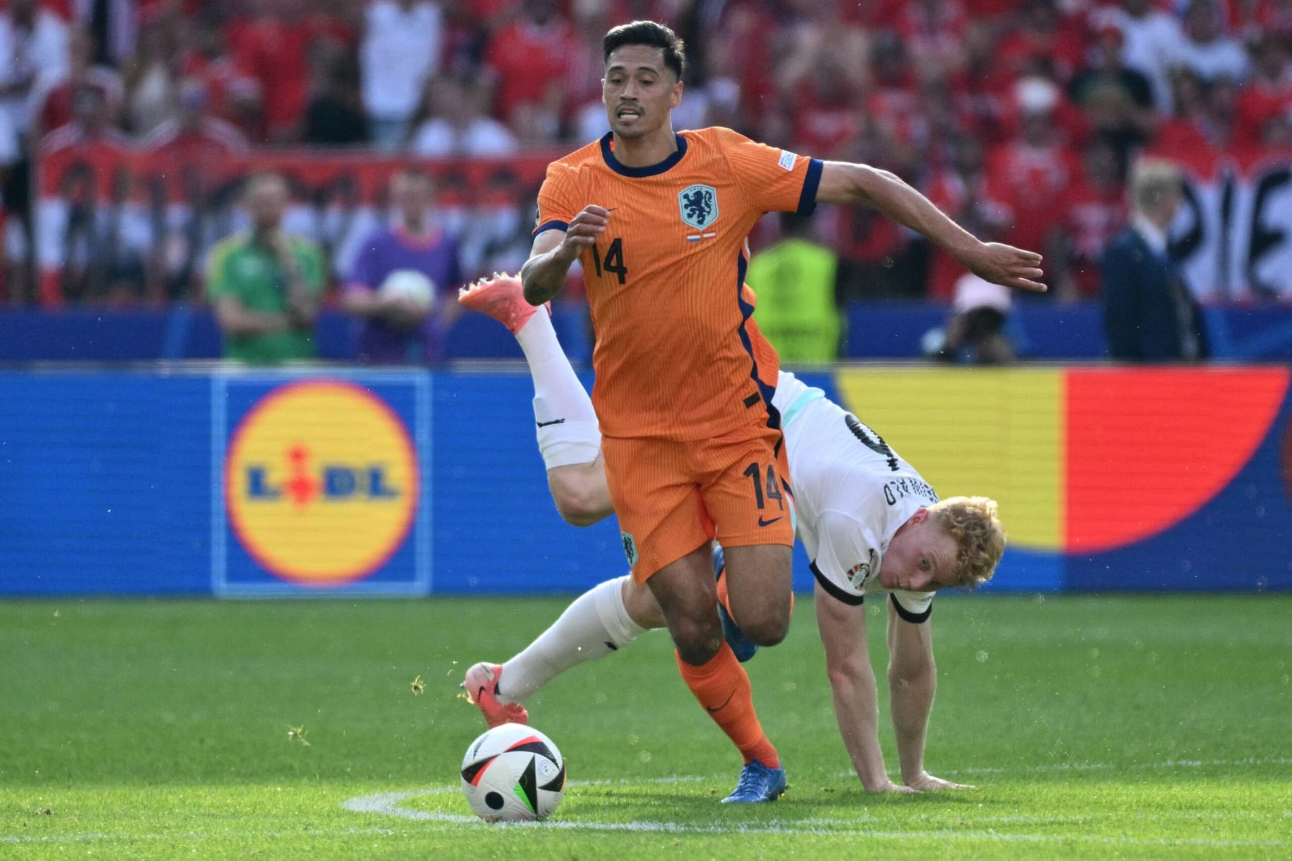 Netherlands' midfielder #14 Tijani Reijnders runs with the ball past Austria's midfielder #06 Nicolas Seiwald during the UEFA Euro 2024 Group D football match between the Netherlands and Austria at the Olympiastadion in Berlin on June 25, 2024. (Photo by Christophe SIMON / AFP) (Photo by CHRISTOPHE SIMON/AFP via Getty Images) Netherlands' midfielder #14 Tijani Reijnders runs with the ball past Austria's midfielder #06 Nicolas Seiwald during the UEFA Euro 2024 Group D football match between the Netherlands and Austria at the Olympiastadion in Berlin on June 25, 2024. (Photo by Christophe SIMON / AFP) (Photo by CHRISTOPHE SIMON/AFP via Getty Images)