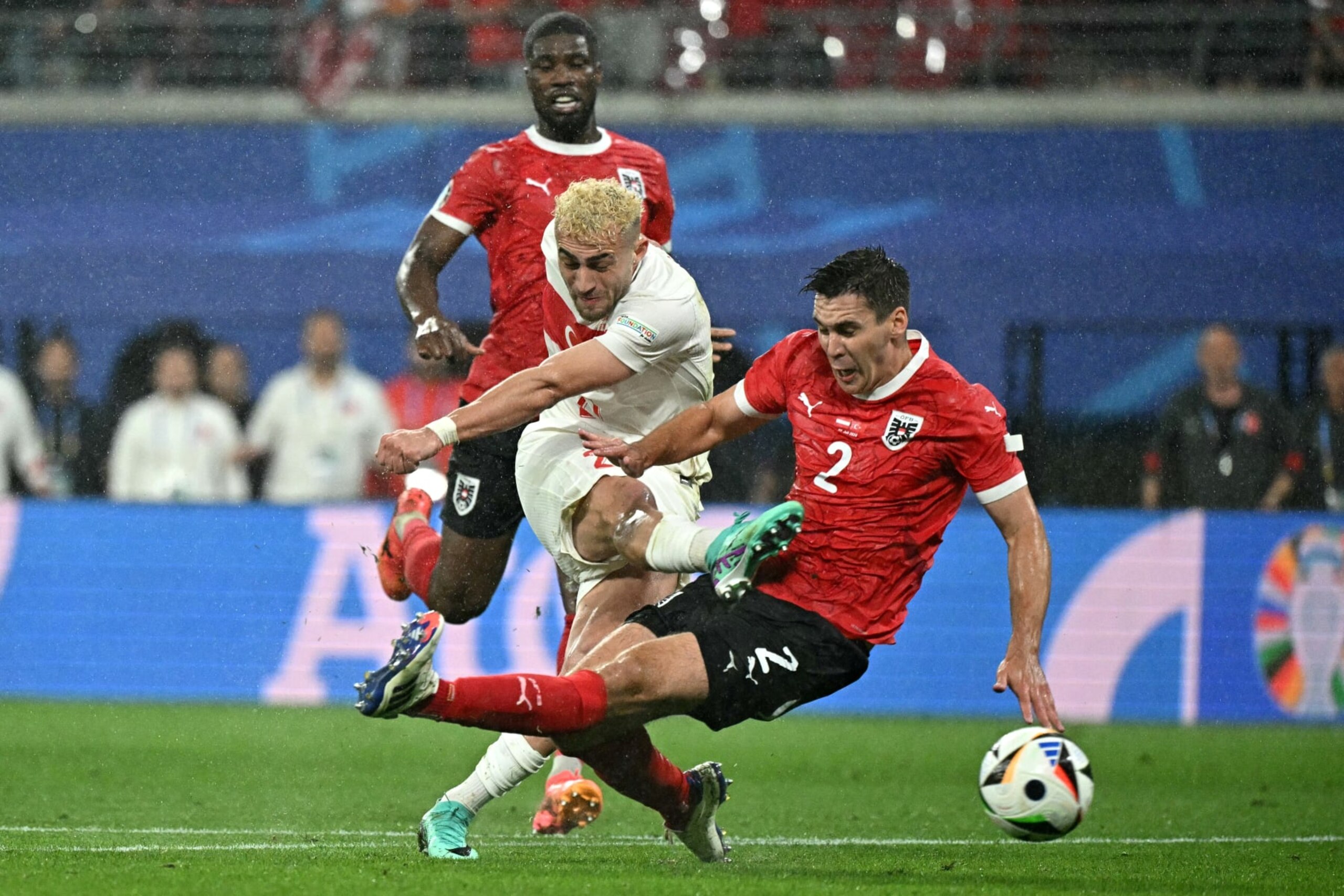 TOPSHOT - Turkey's forward #21 Baris Alper Yilmaz (C) kicks to goal past Austria's defender #02 Maximilian Woeber during the UEFA Euro 2024 round of 16 football match between Austria and Turkey at the Leipzig Stadium in Leipzig on July 2, 2024. (Photo by JAVIER SORIANO / AFP) (Photo by JAVIER SORIANO/AFP via Getty Images) TOPSHOT - Turkey's forward #21 Baris Alper Yilmaz (C) kicks to goal past Austria's defender #02 Maximilian Woeber during the UEFA Euro 2024 round of 16 football match between Austria and Turkey at the Leipzig Stadium in Leipzig on July 2, 2024. (Photo by JAVIER SORIANO / AFP) (Photo by JAVIER SORIANO/AFP via Getty Images)