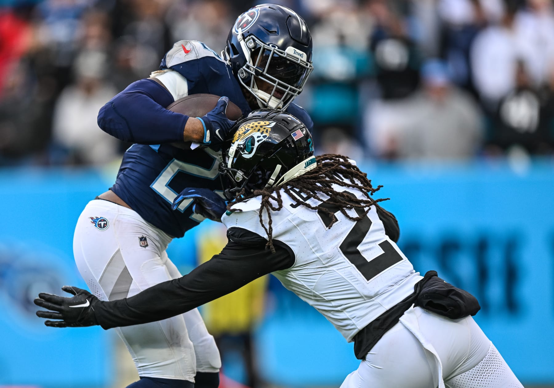 NASHVILLE, TN - JANUARY 07: Jacksonville Jaguars safety Rayshawn Jenkins (2) tackles Tennessee Titans running back Derrick Henry (22) during the NFL game between the Tennessee Titans and the Jacksonville Jaguars on January 7, 2024, at Nissan Stadium in Nashville, TN. (Photo by Bryan Lynn/Icon Sportswire via Getty Images)