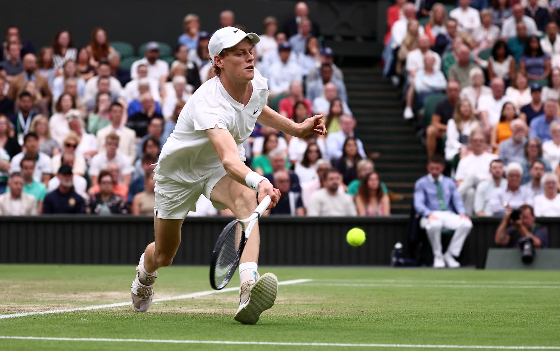 Italy's Jannik Sinner returns against Russia's Daniil Medvedev during their men's singles quarter-final tennis match on the ninth day of the 2024 Wimbledon Championships at The All England Lawn Tennis and Croquet Club in Wimbledon, southwest London, on July 9, 2024. (Photo by HENRY NICHOLLS / AFP) / RESTRICTED TO EDITORIAL USE (Photo by HENRY NICHOLLS/AFP via Getty Images)