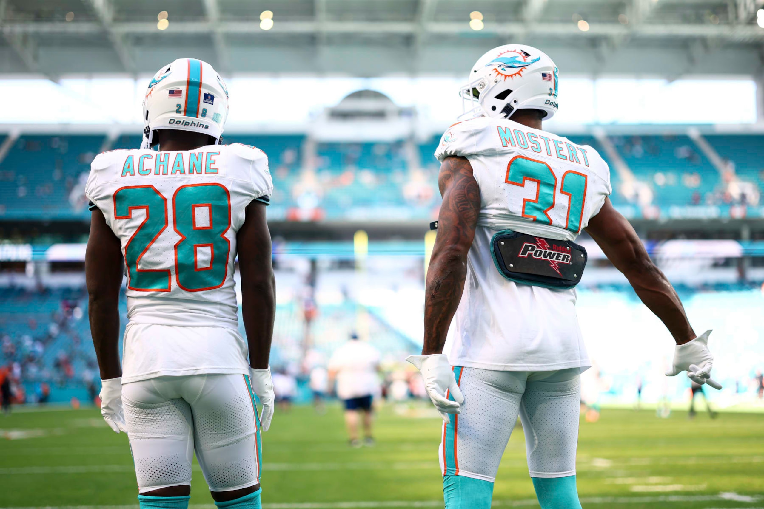 MIAMI GARDENS, FL - DECEMBER 17: De'Von Achane #28 and Raheem Mostert #31 of the Miami Dolphins warm up prior to an NFL football game against the New York Jets at Hard Rock Stadium on December 17, 2023 in Miami Gardens, Florida. (Photo by Kevin Sabitus/Getty Images)