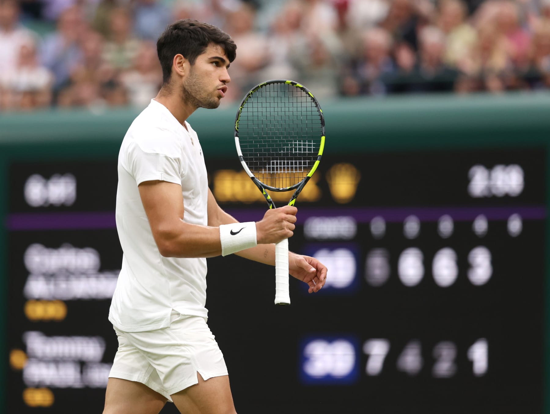 LONDON, ENGLAND - JULY 09: Carlos Alcaraz of Spain reacts as he plays against Tommy Paul of United States in the Gentlemen's Singles Quarter Final match during day nine of The Championships Wimbledon 2024 at All England Lawn Tennis and Croquet Club on July 09, 2024 in London, England. (Photo by Clive Brunskill/Getty Images)