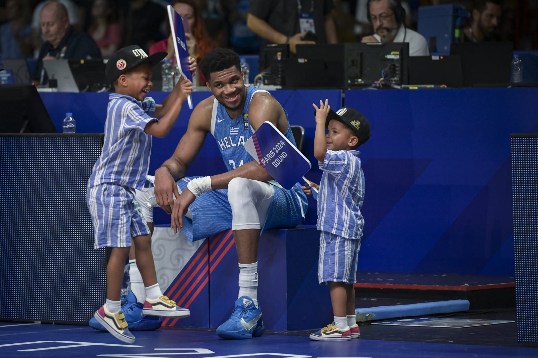 Greece's Giannis Antetokoumpo reacts with his children as he celebrates the win at the end of the final game of the FIBA Olympic Qualifying Tournament between Croatia and Greece to be qualified for the Paris 2024 Olympics and Paralympics games, at the Peace and Friendship Stadium in Athens on July 7, 2024. (Photo by Aris MESSINIS / AFP) (Photo by ARIS MESSINIS/AFP via Getty Images)