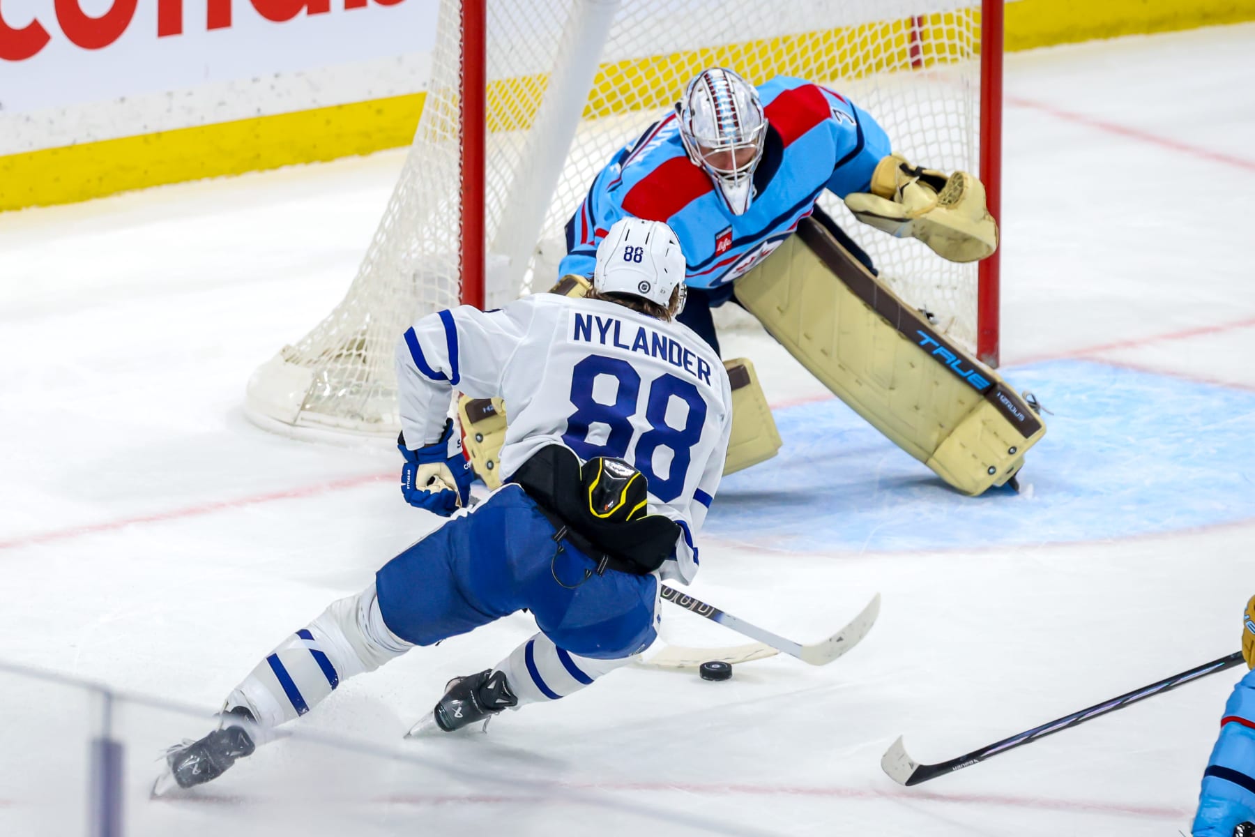 WINNIPEG, CANADA - JANUARY 27: William Nylander #88 of the Toronto Maple Leafs moves in for the shot against goaltender Connor Hellebuyck #37 of the Winnipeg Jets during second period action at Canada Life Centre on January 27, 2024 in Winnipeg, Manitoba, Canada. (Photo by Jonathan Kozub/NHLI via Getty Images)
