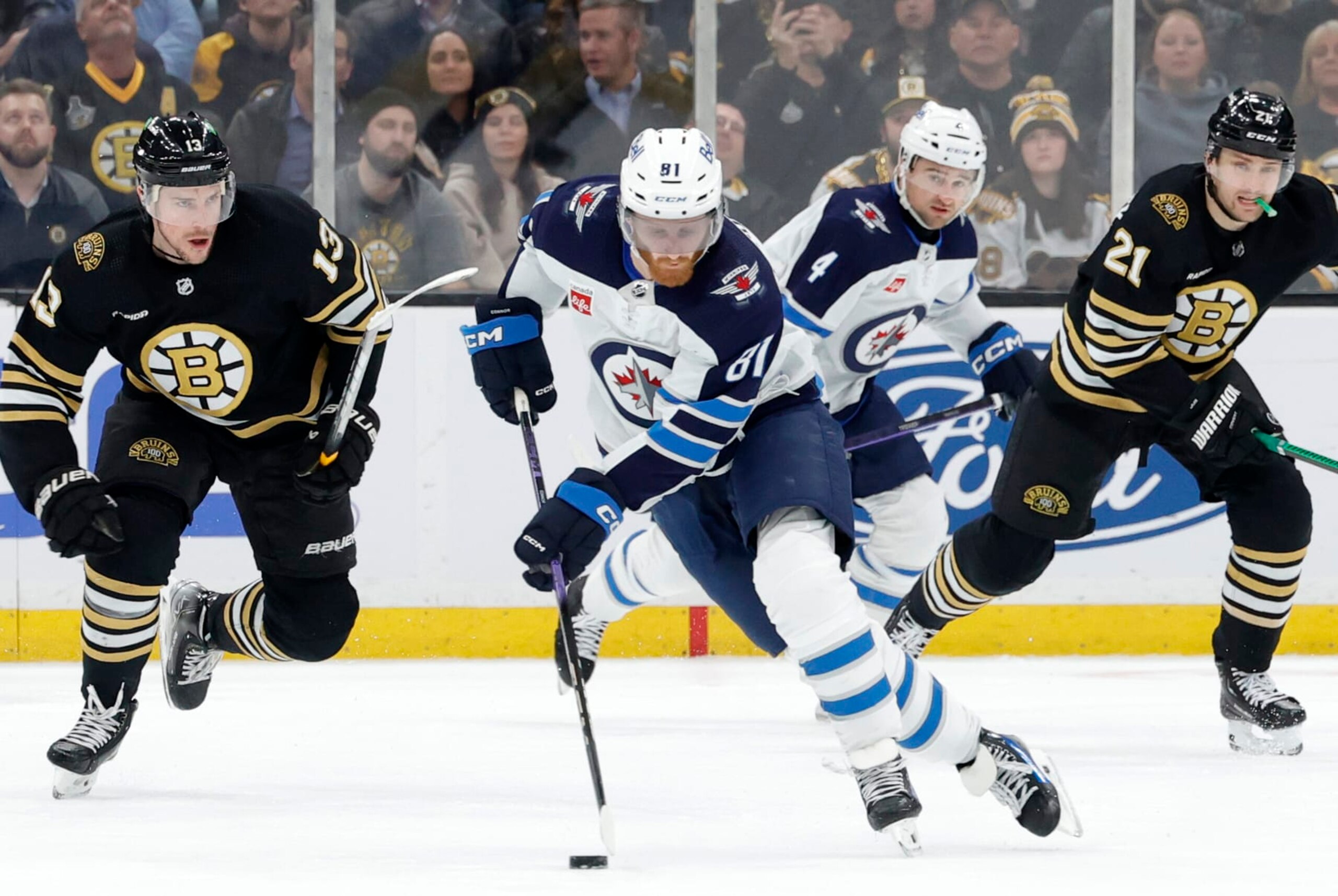 BOSTON, MA - JANUARY 22: Winnipeg Jets left wing Kyle Connor (81) picks up the puck during a game between the Boston Bruins and the Winnipeg Jets on January 22, 2024, at TD Garden in Boston, Massachusetts. (Photo by Fred Kfoury III/Icon Sportswire via Getty Images)