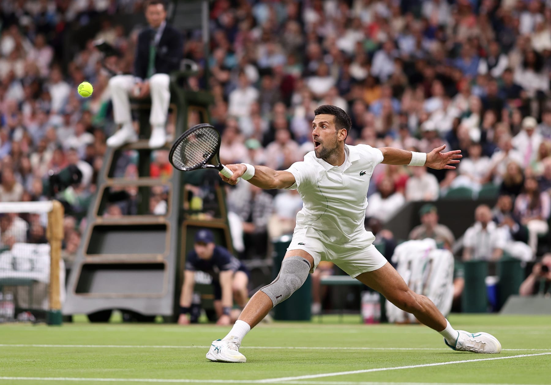 LONDON, ENGLAND - JULY 08: Novak Djokovic of Serbia plays a backhand against Holger Rune of Denmark in his Gentlemen's Singles fourth round match during day eight of The Championships Wimbledon 2024 at All England Lawn Tennis and Croquet Club on July 08, 2024 in London, England. (Photo by Julian Finney/Getty Images)